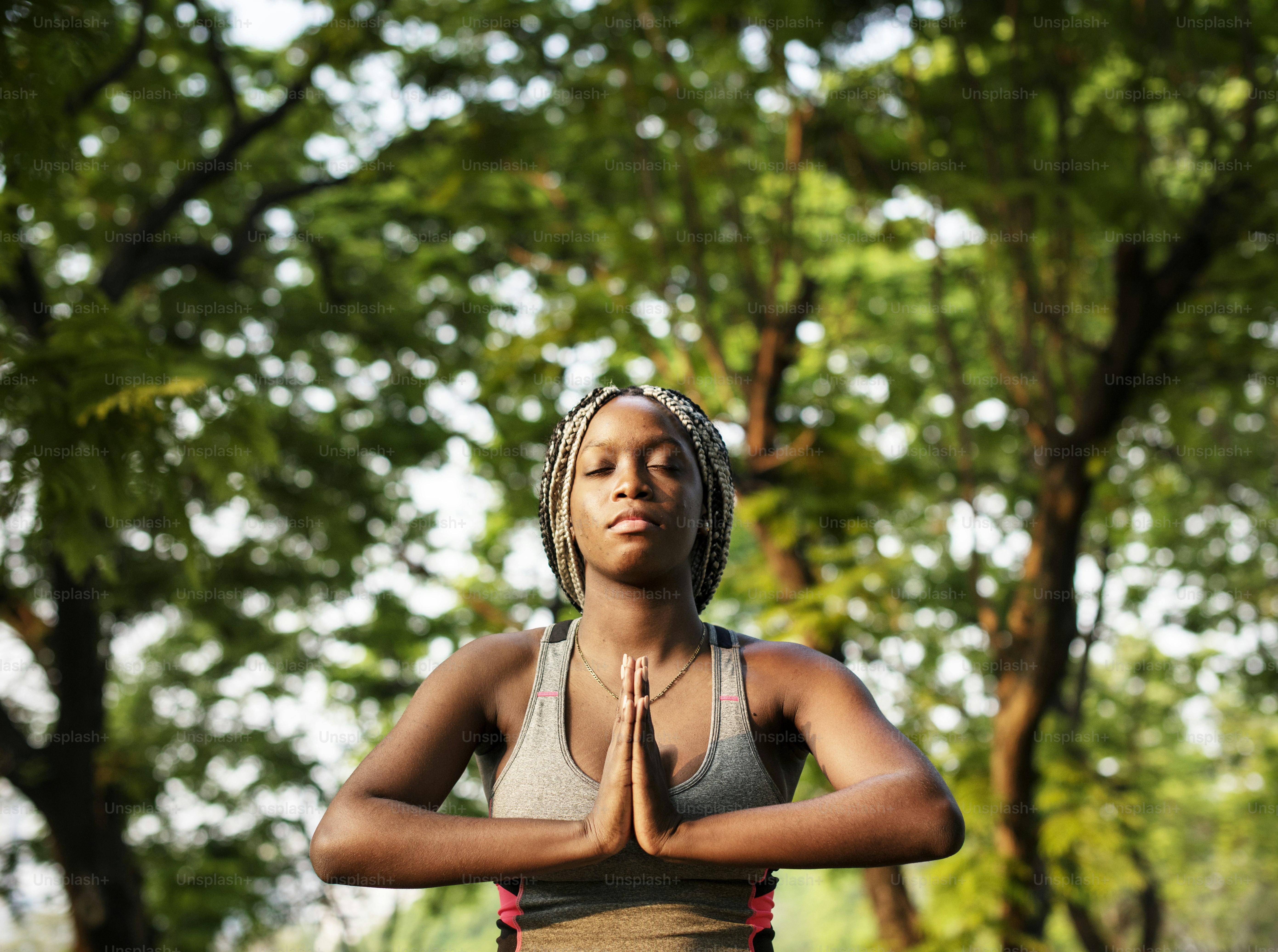 A woman doing yoga in the park