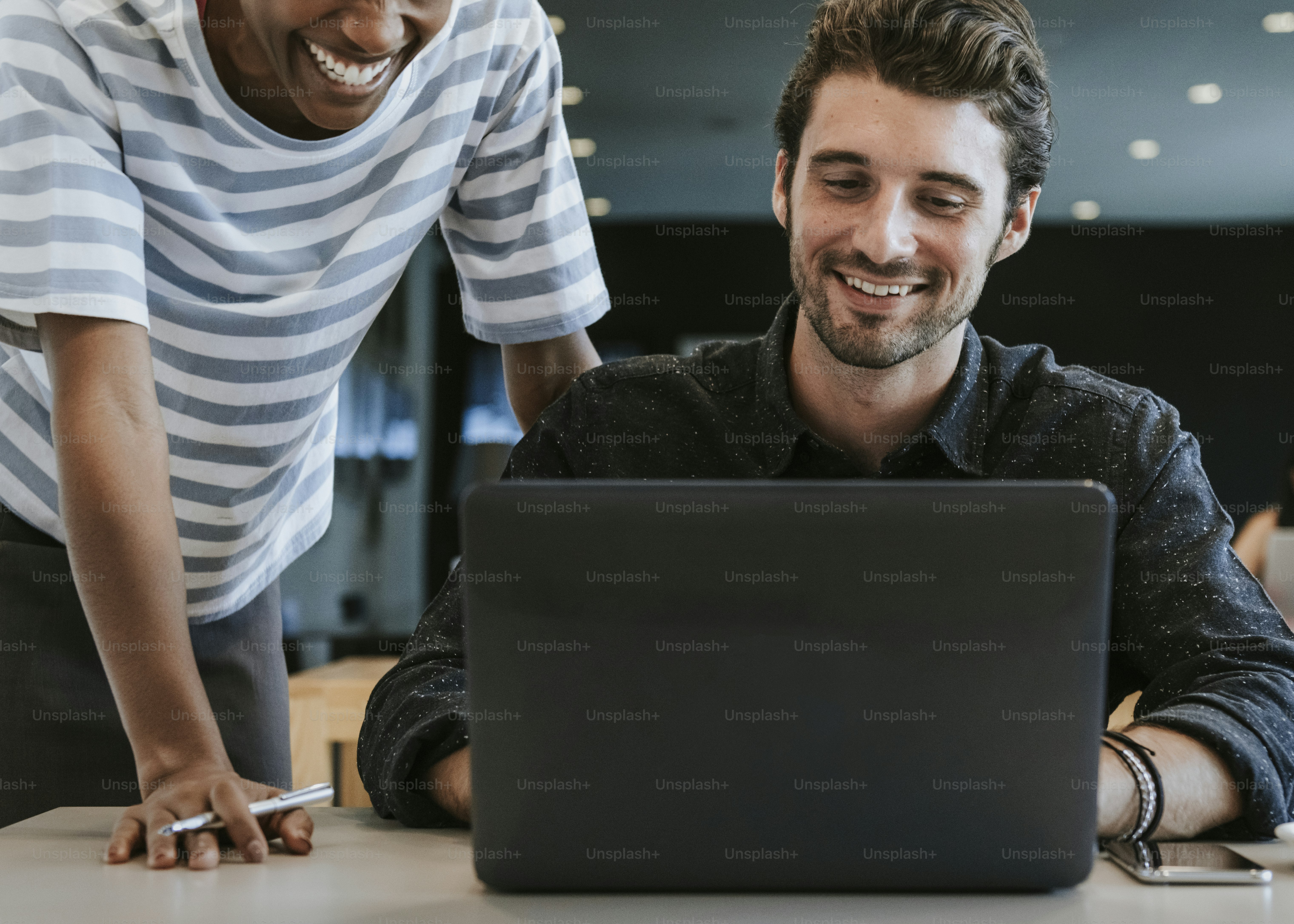 Colleagues discussing their work on a laptop