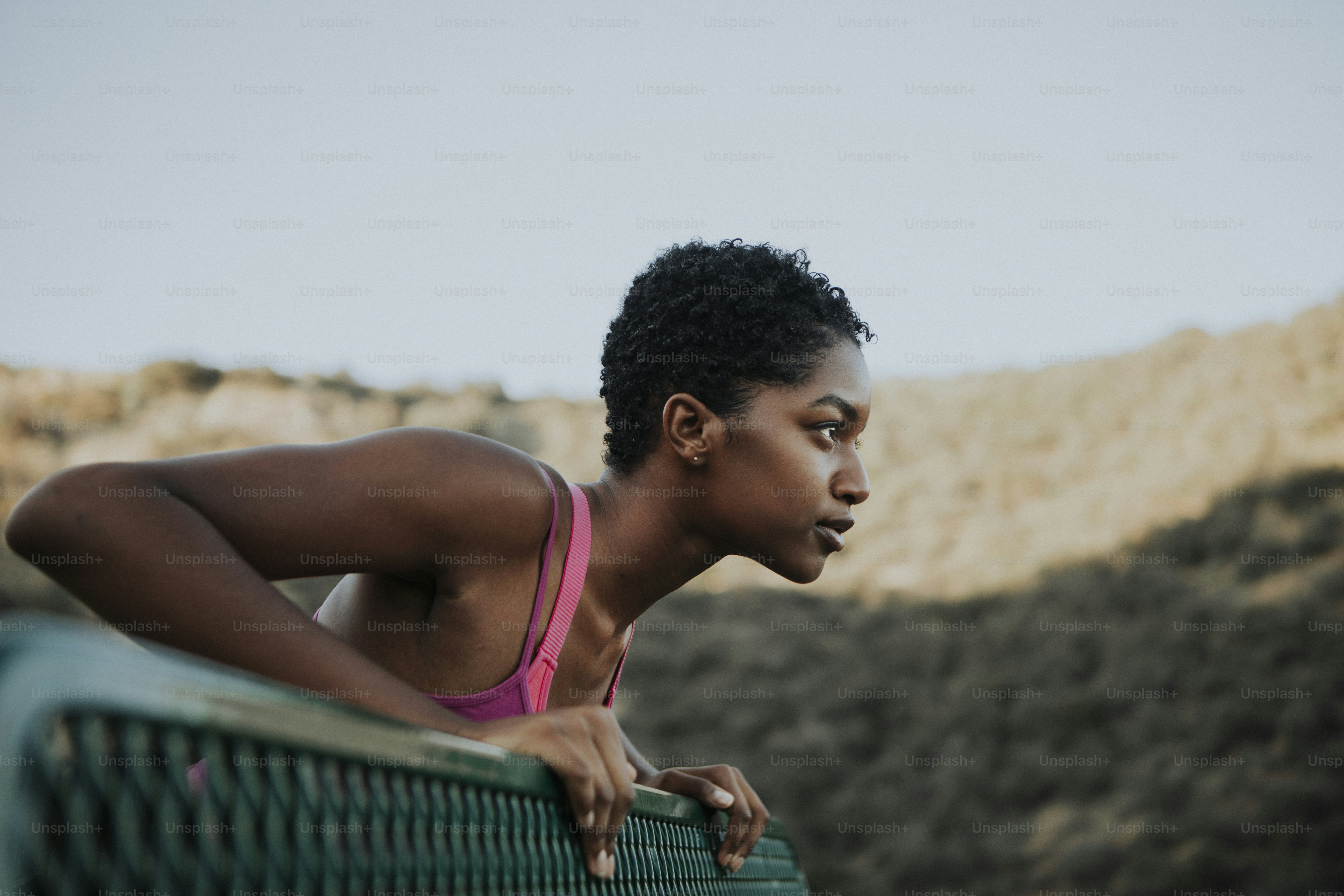 Woman stretching against a park bench