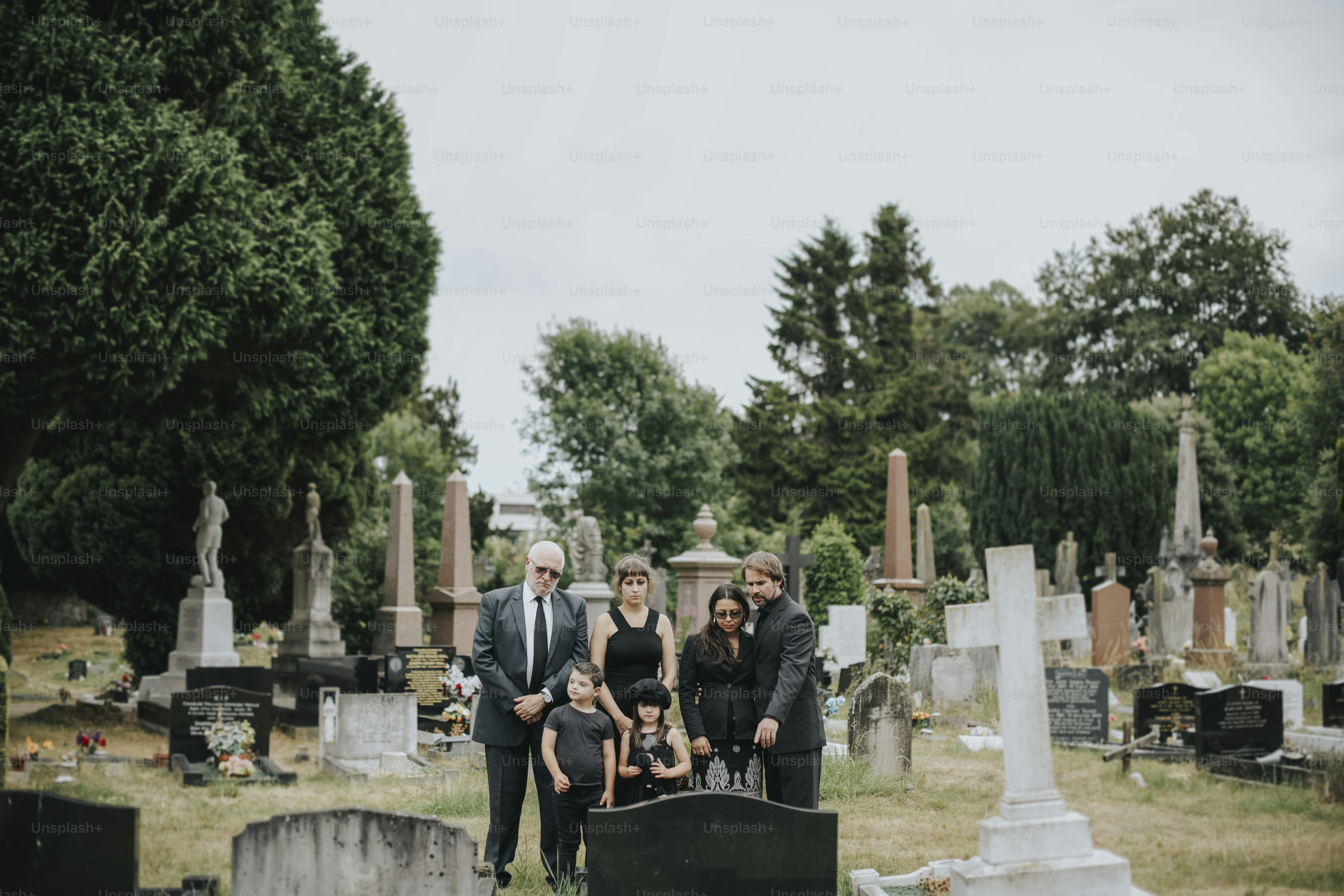 Family giving their last goodbyes at the cemetery