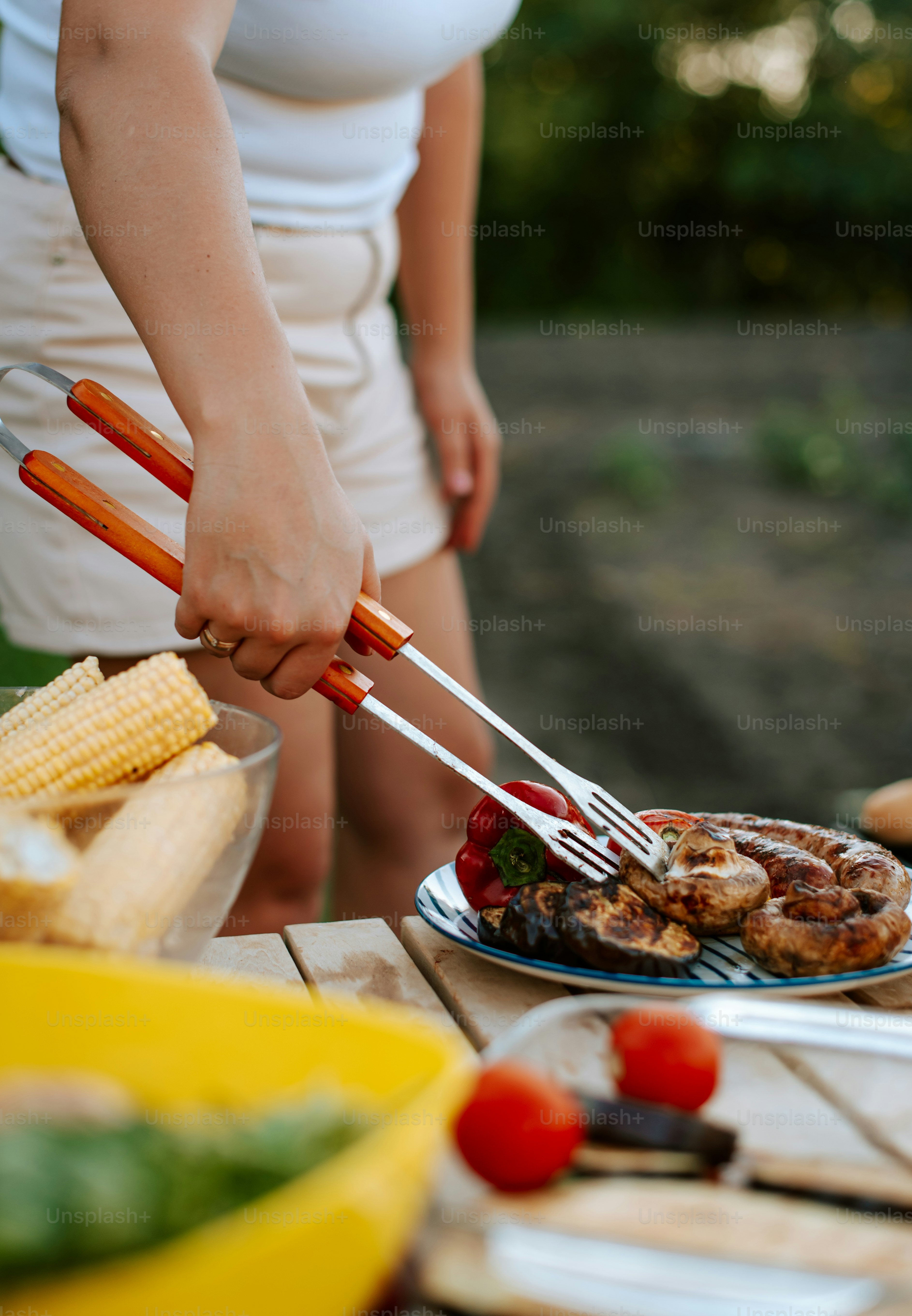 A woman preparing food on top of a wooden table