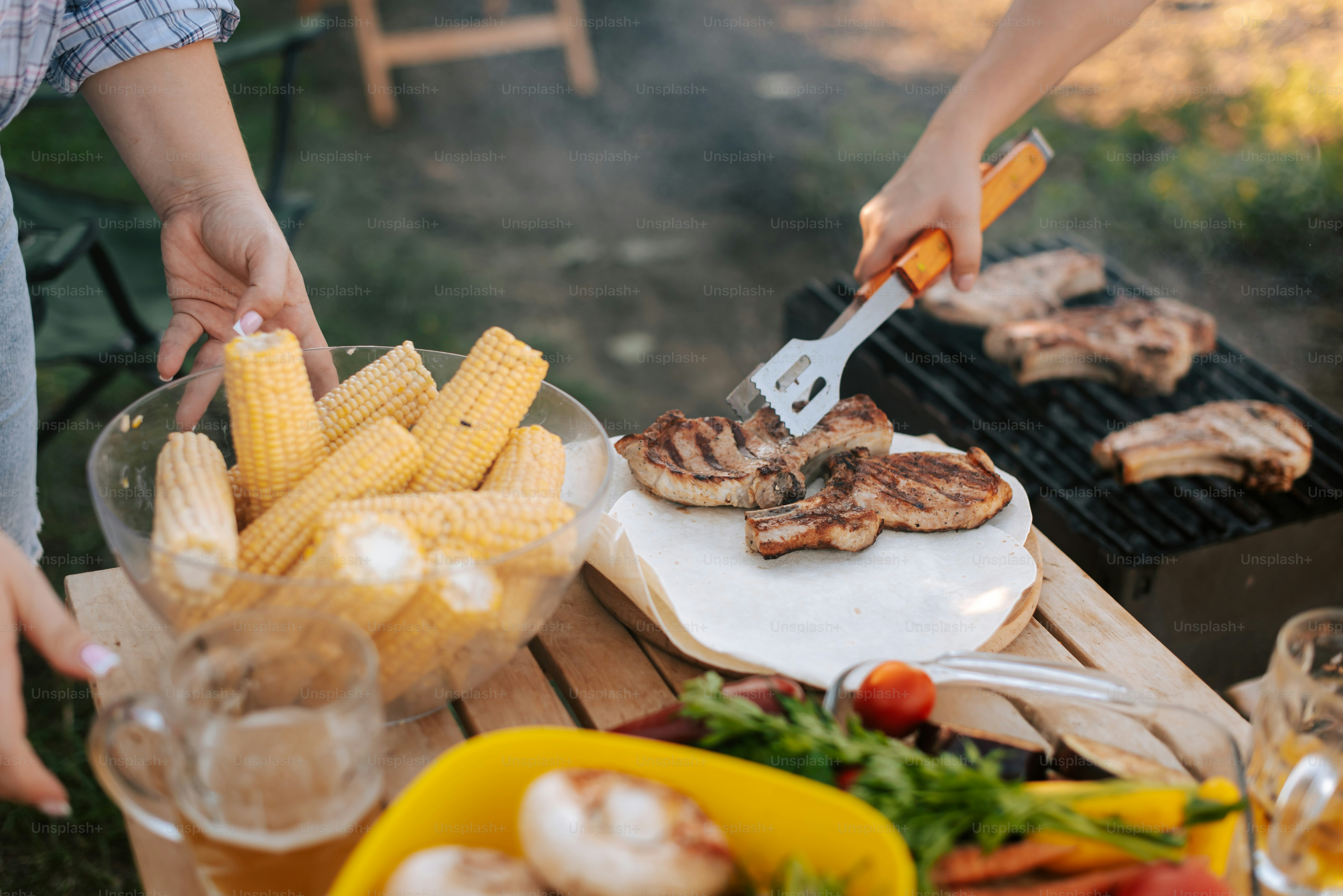 A man and a woman cooking food on a grill