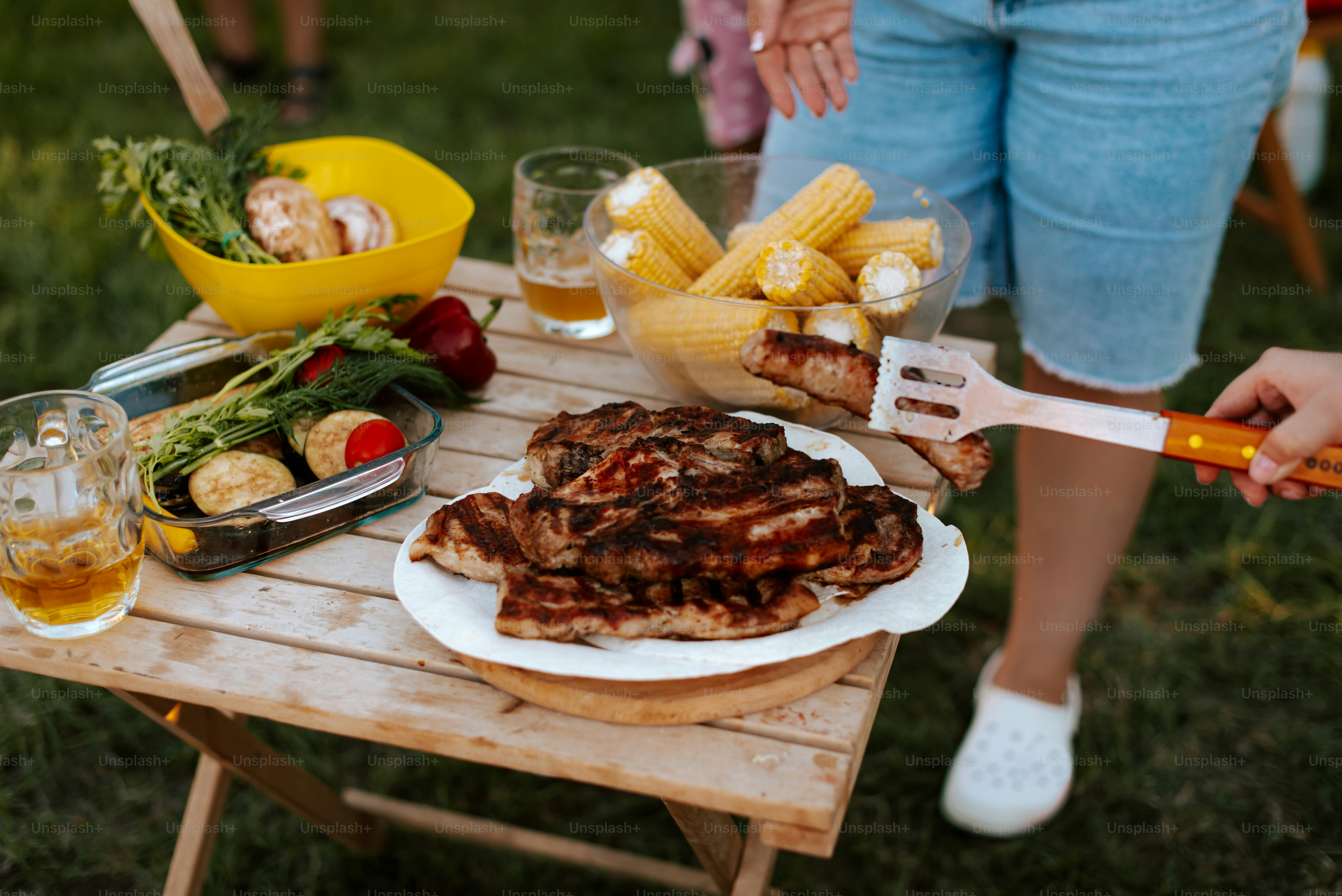 A person holding a knife over a plate of food