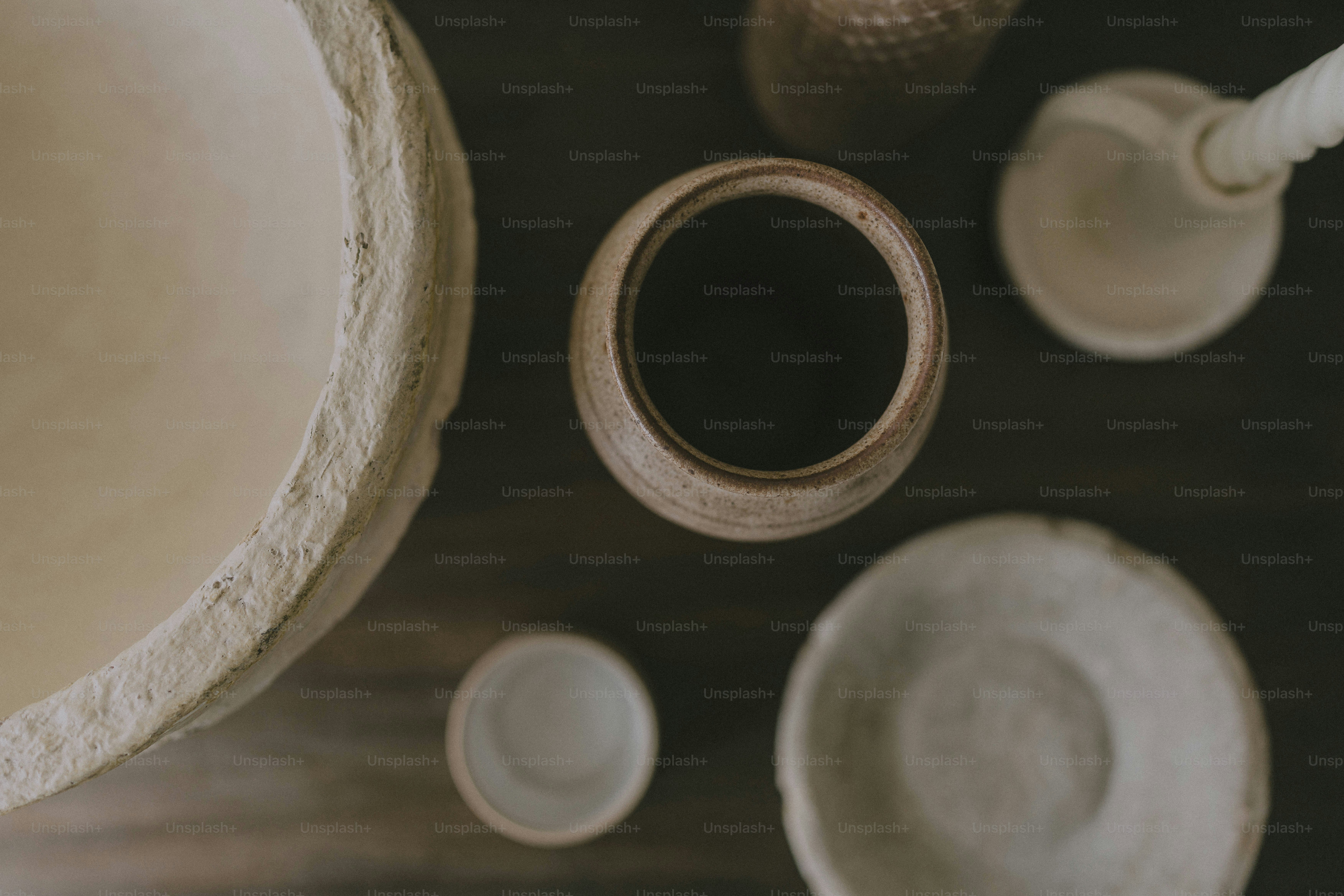 A wooden table topped with bowls and cups
