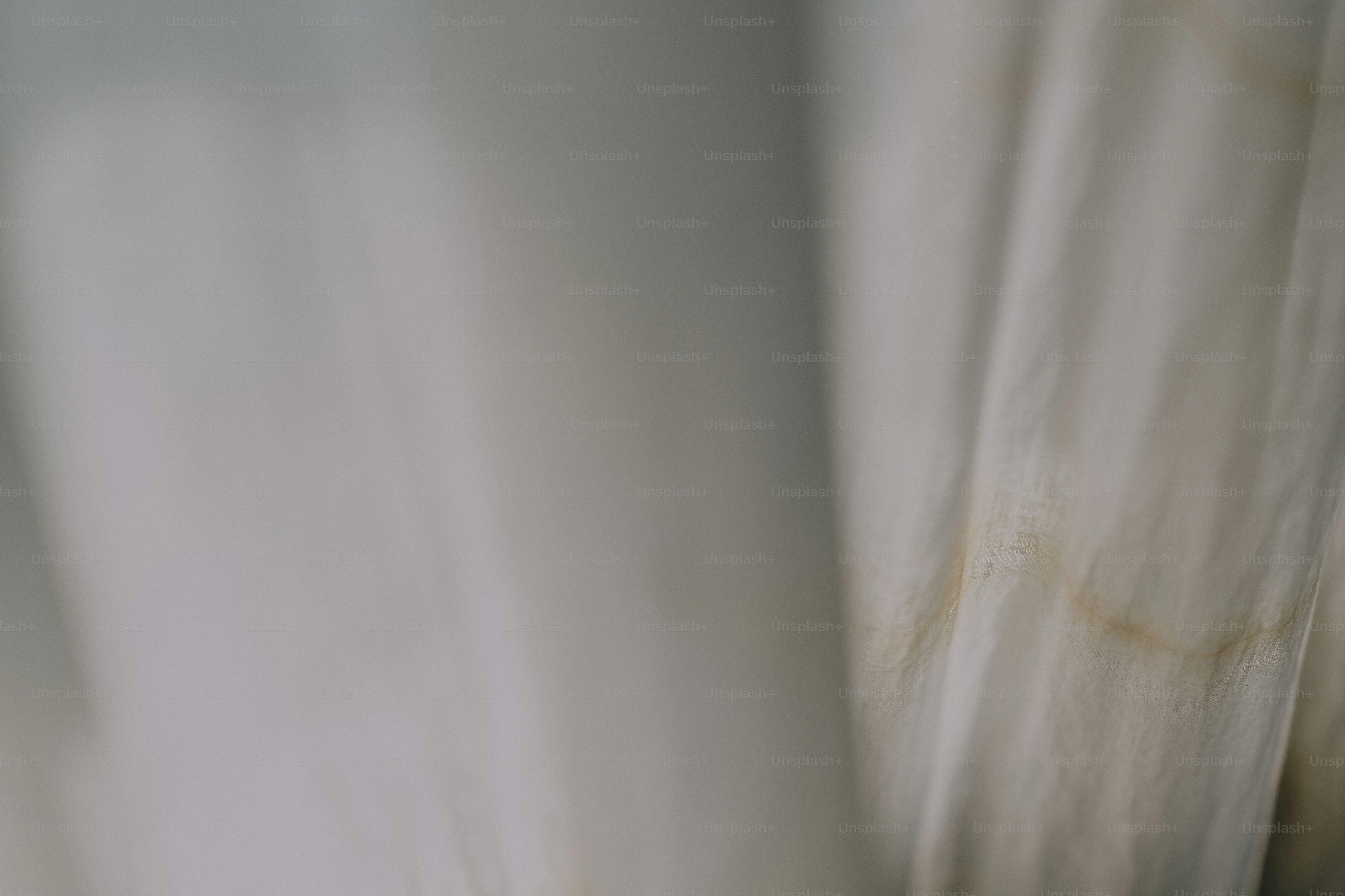 A blurry photo of a white curtain