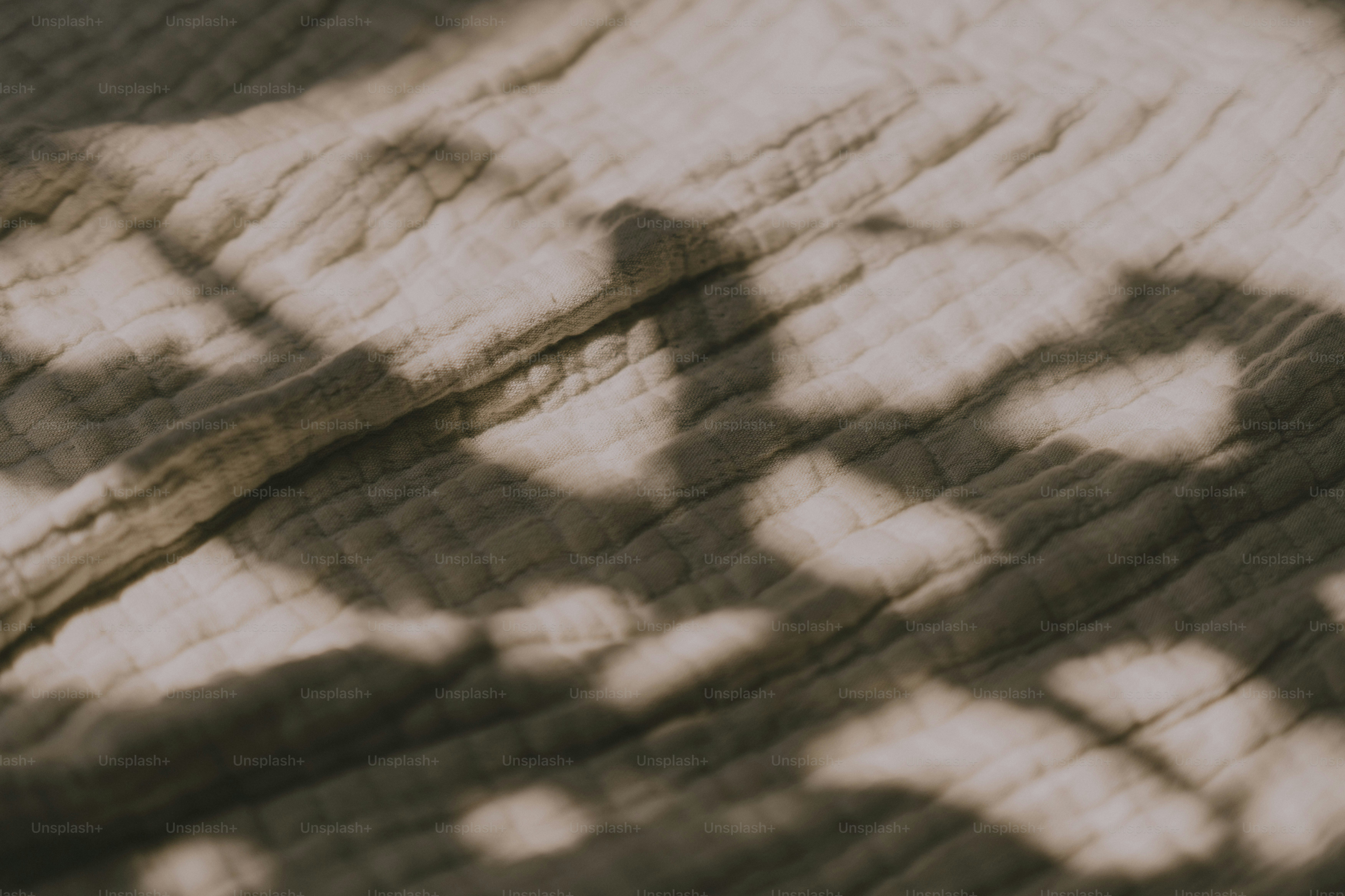 A shadow of a person on a bed