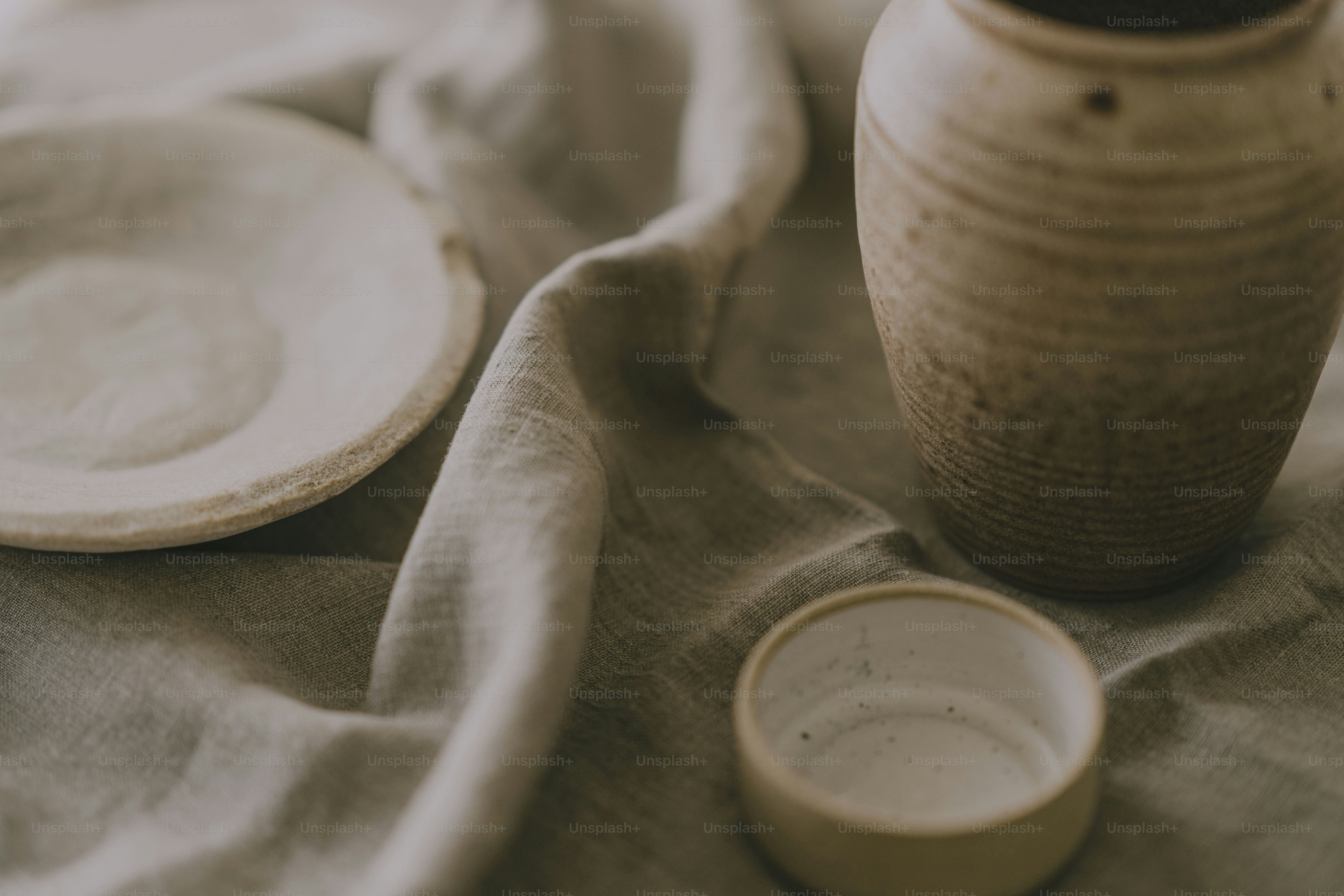 A white vase sitting on top of a table