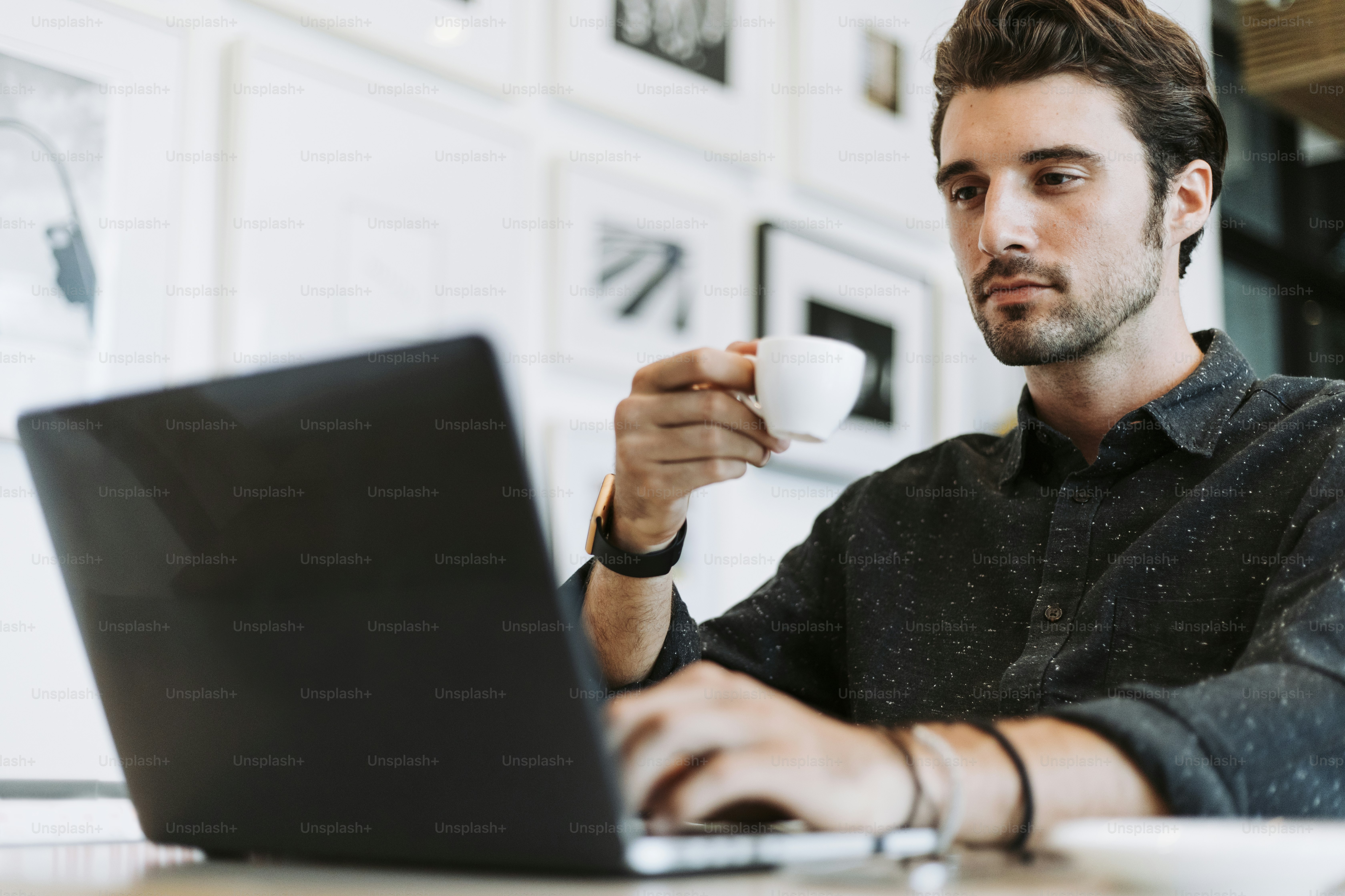 Man drinking coffee while working