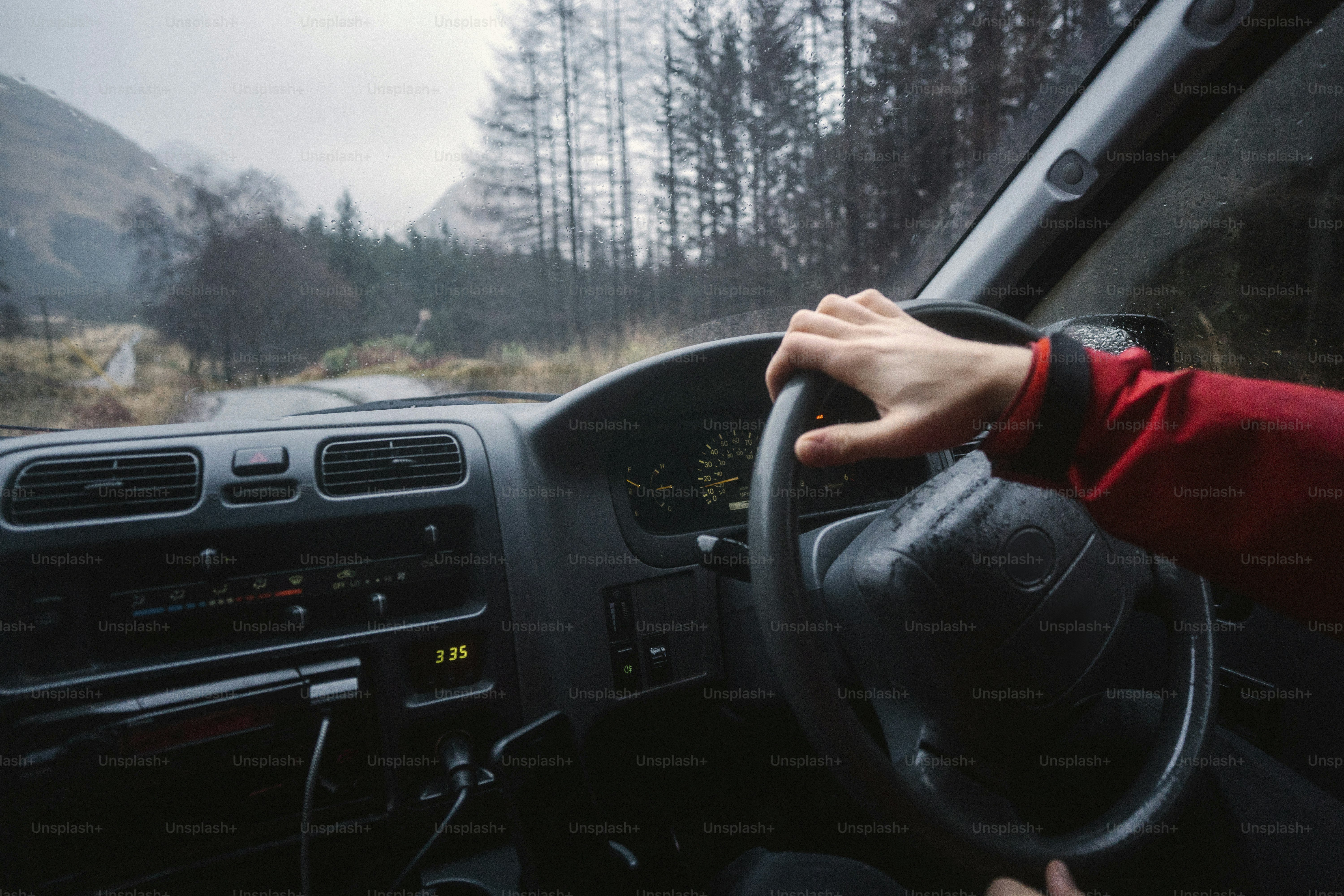 Man driving a car in the Highlands, Scotland