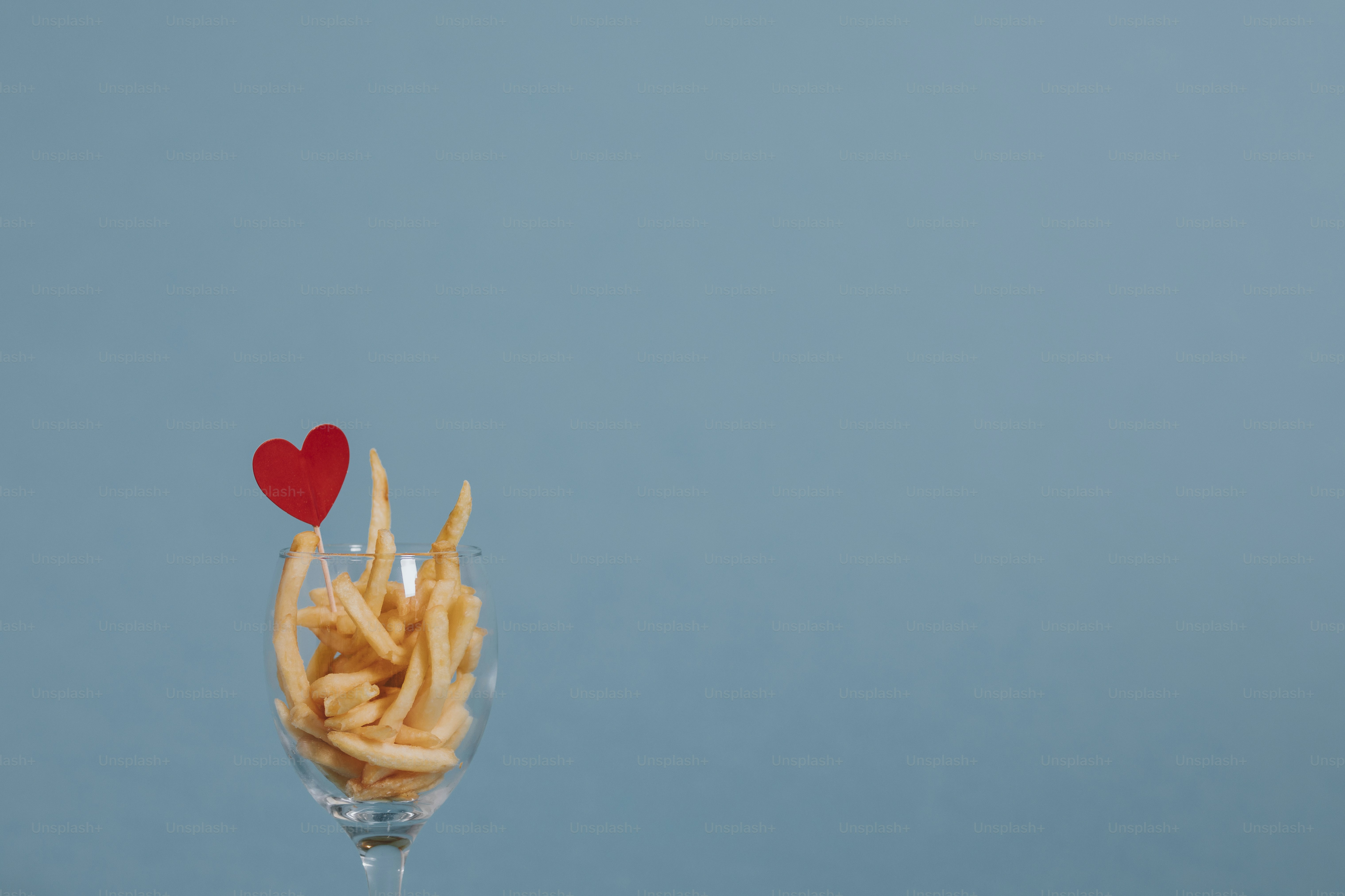 French fries in a wine glass with a heart ornament