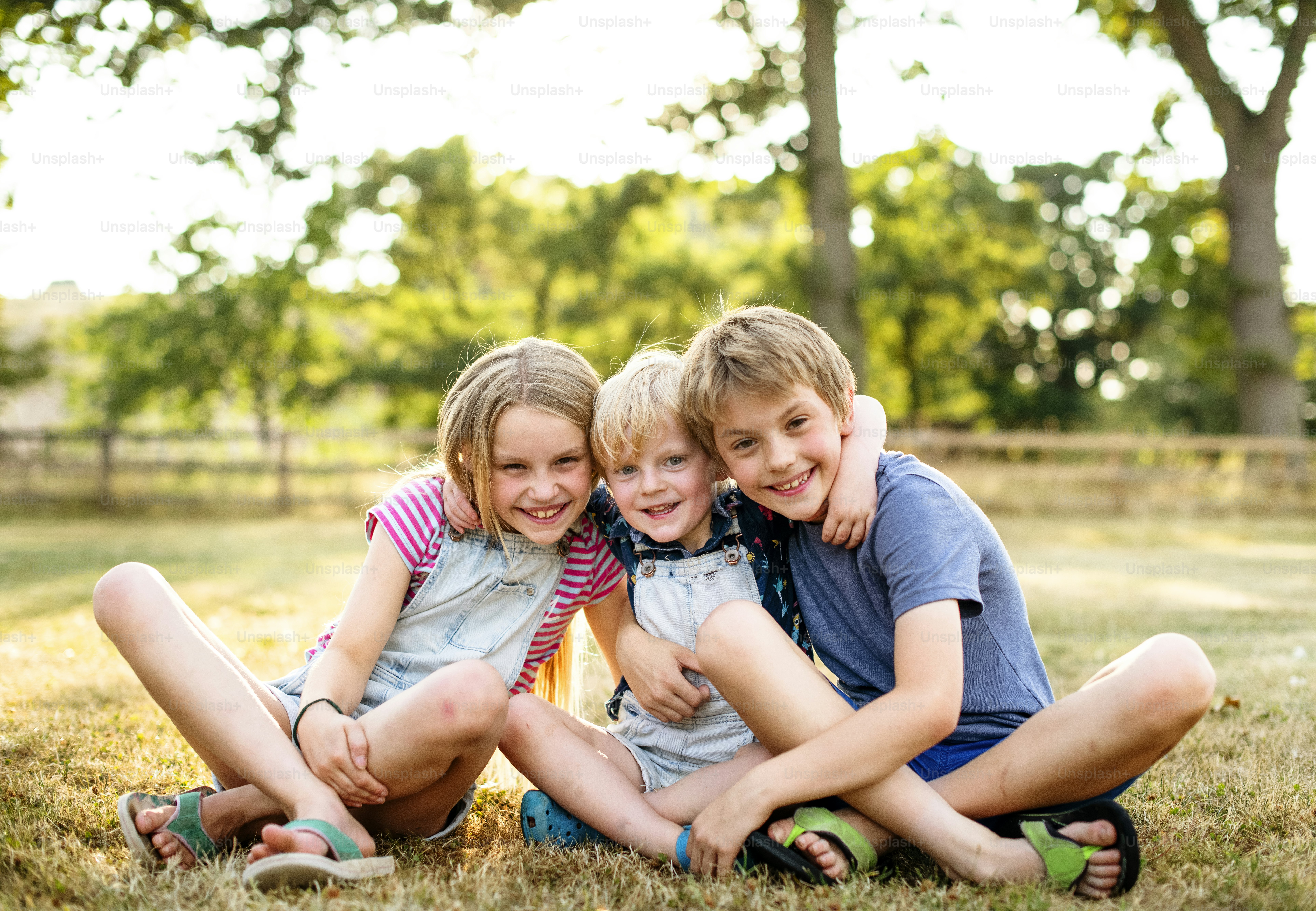 Siblings putting their arms around each other
