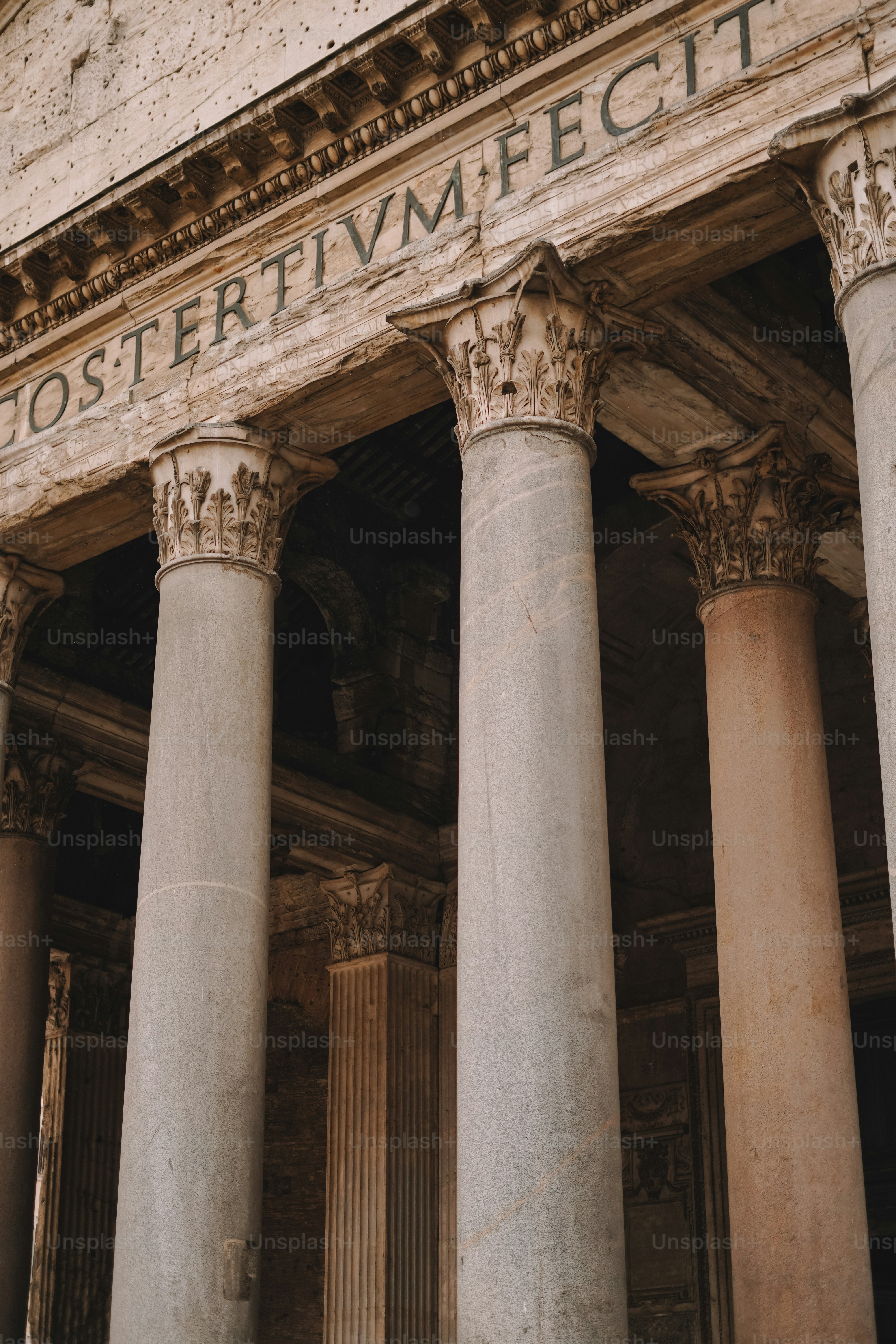 An old building with columns and a sign on it