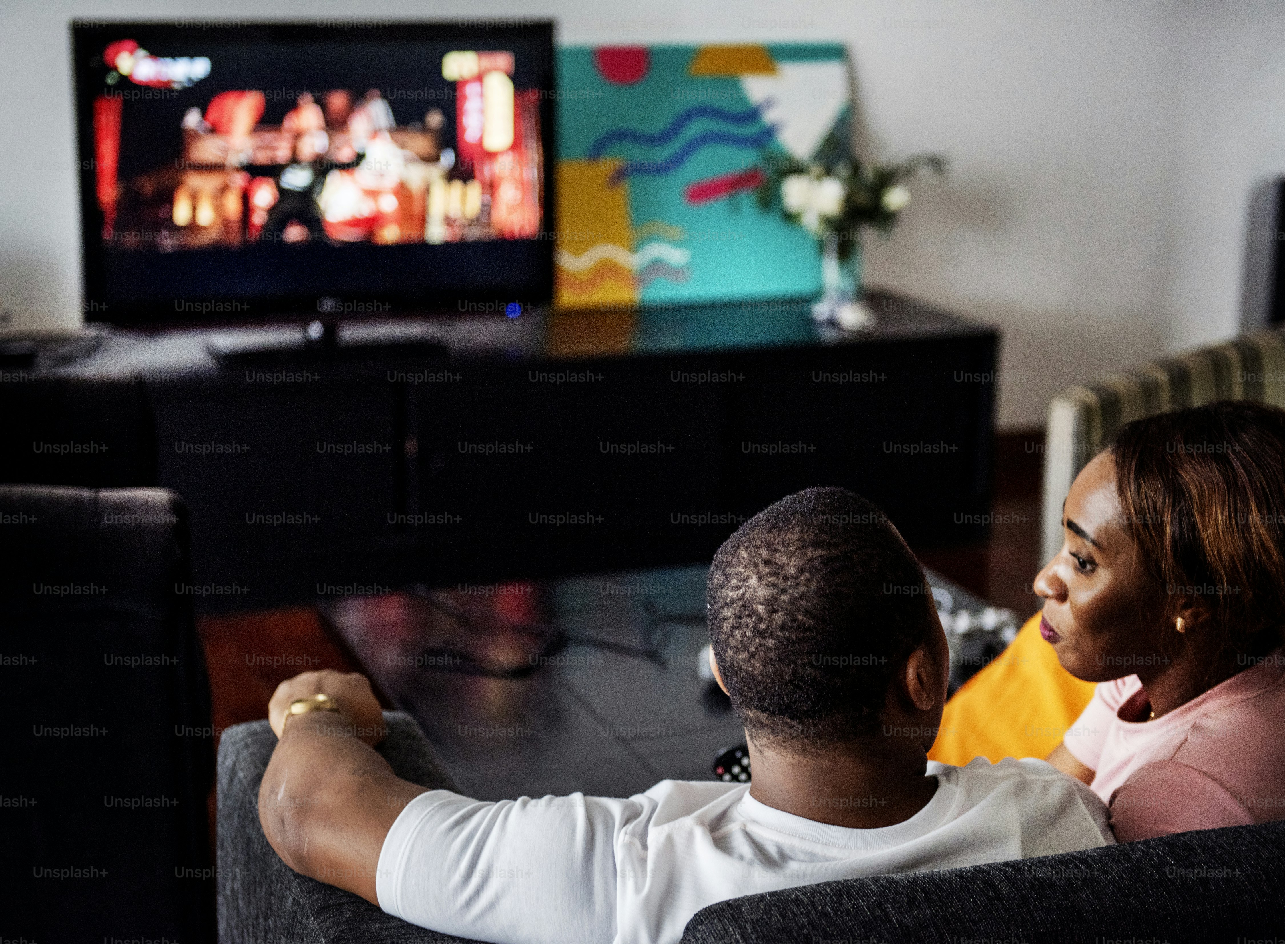 Black spouse watching movie enjoy precious time together