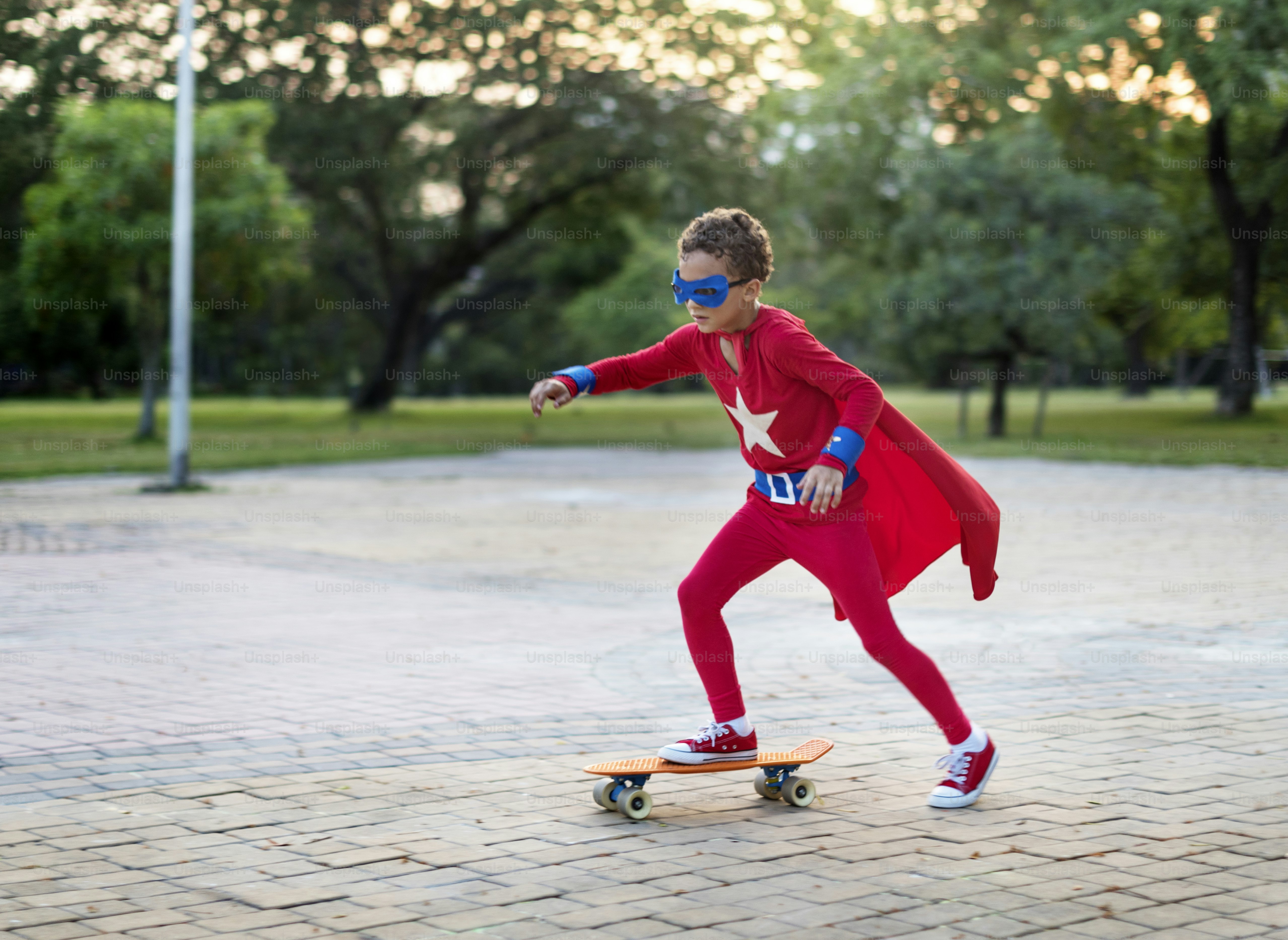 Superhero boy on a skateboard