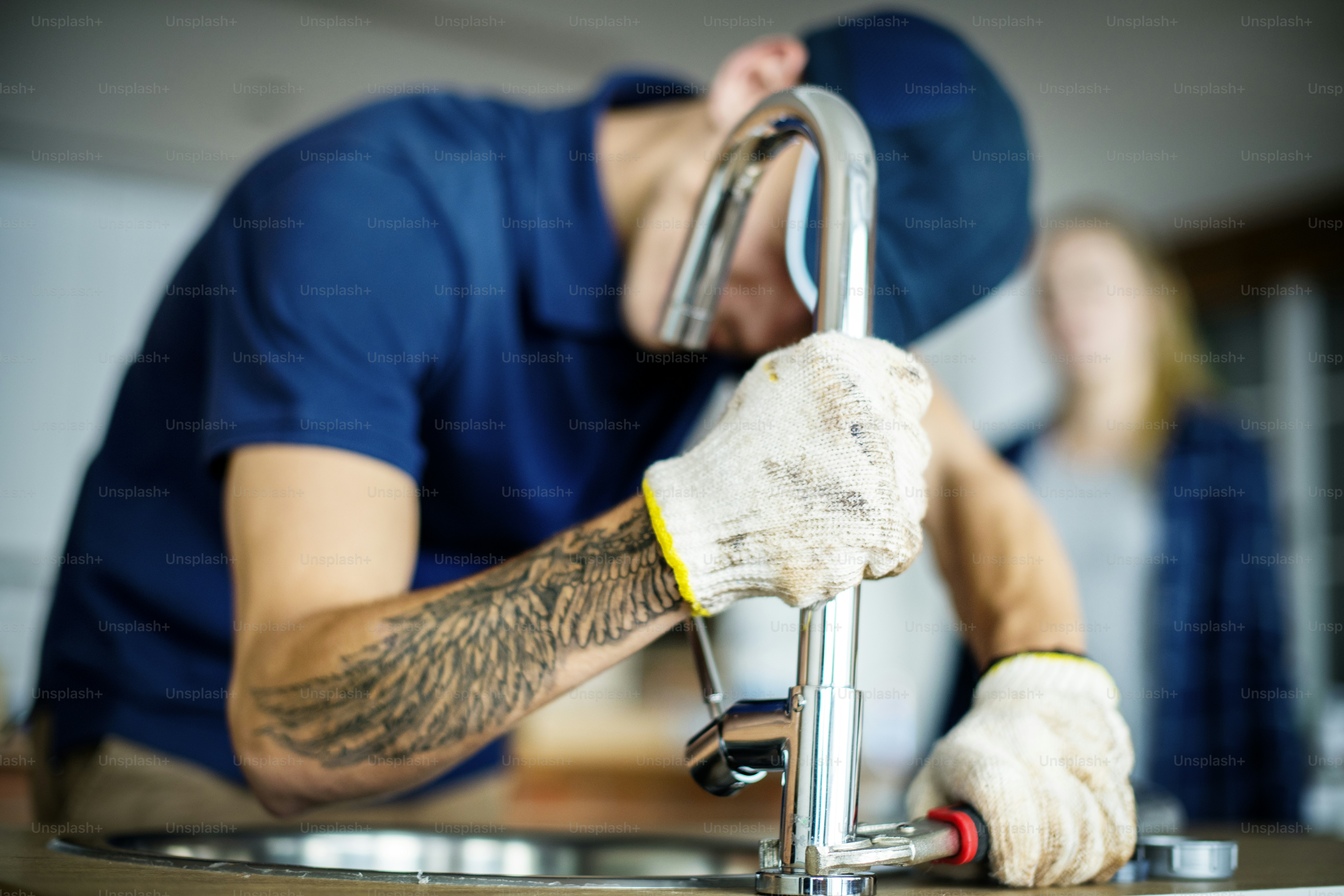 Close-up of a skilled worker welding steel pipes in an industrial setting, showcasing expertise and safety gear.