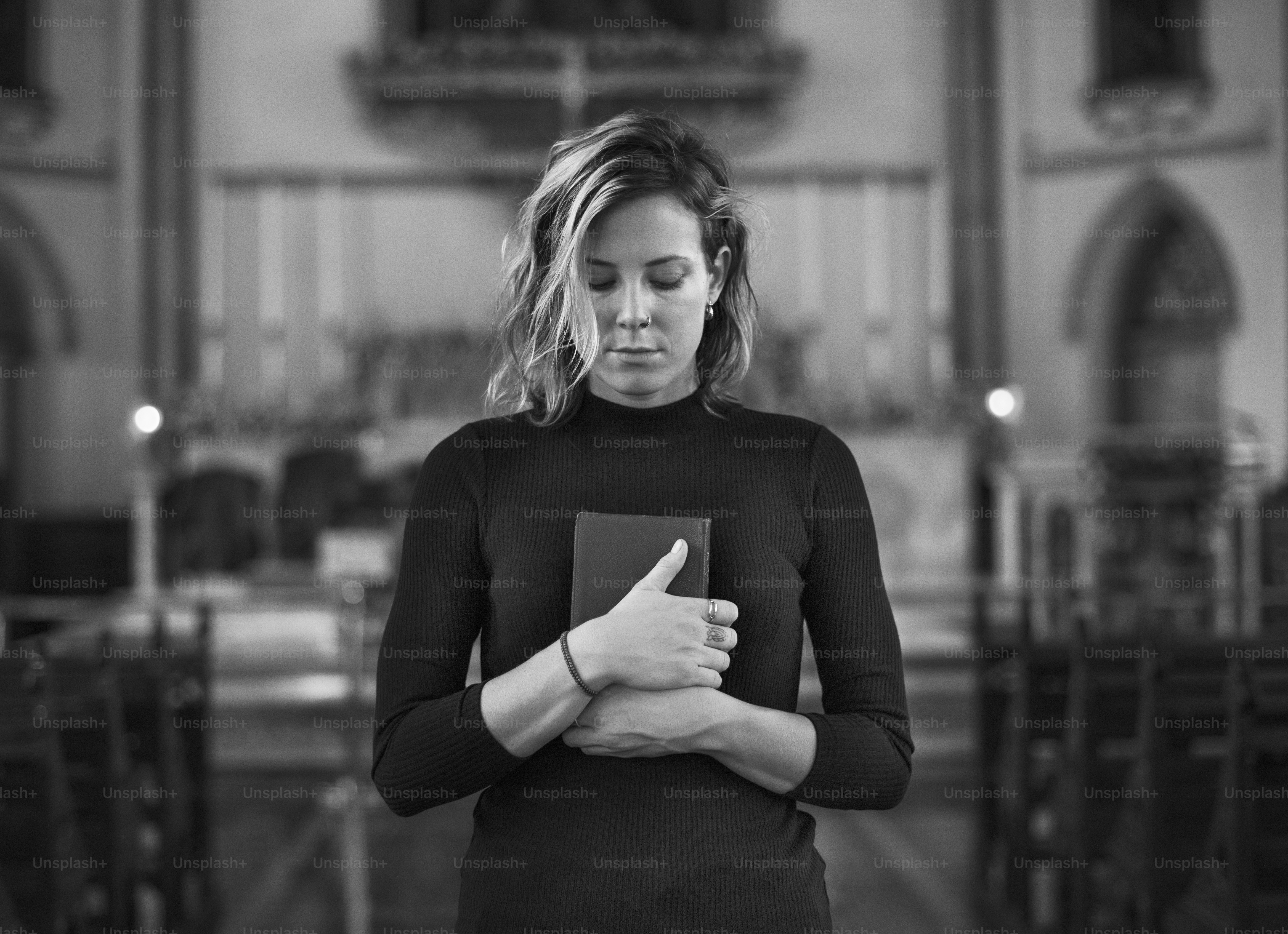 Woman praying in the church grayscale