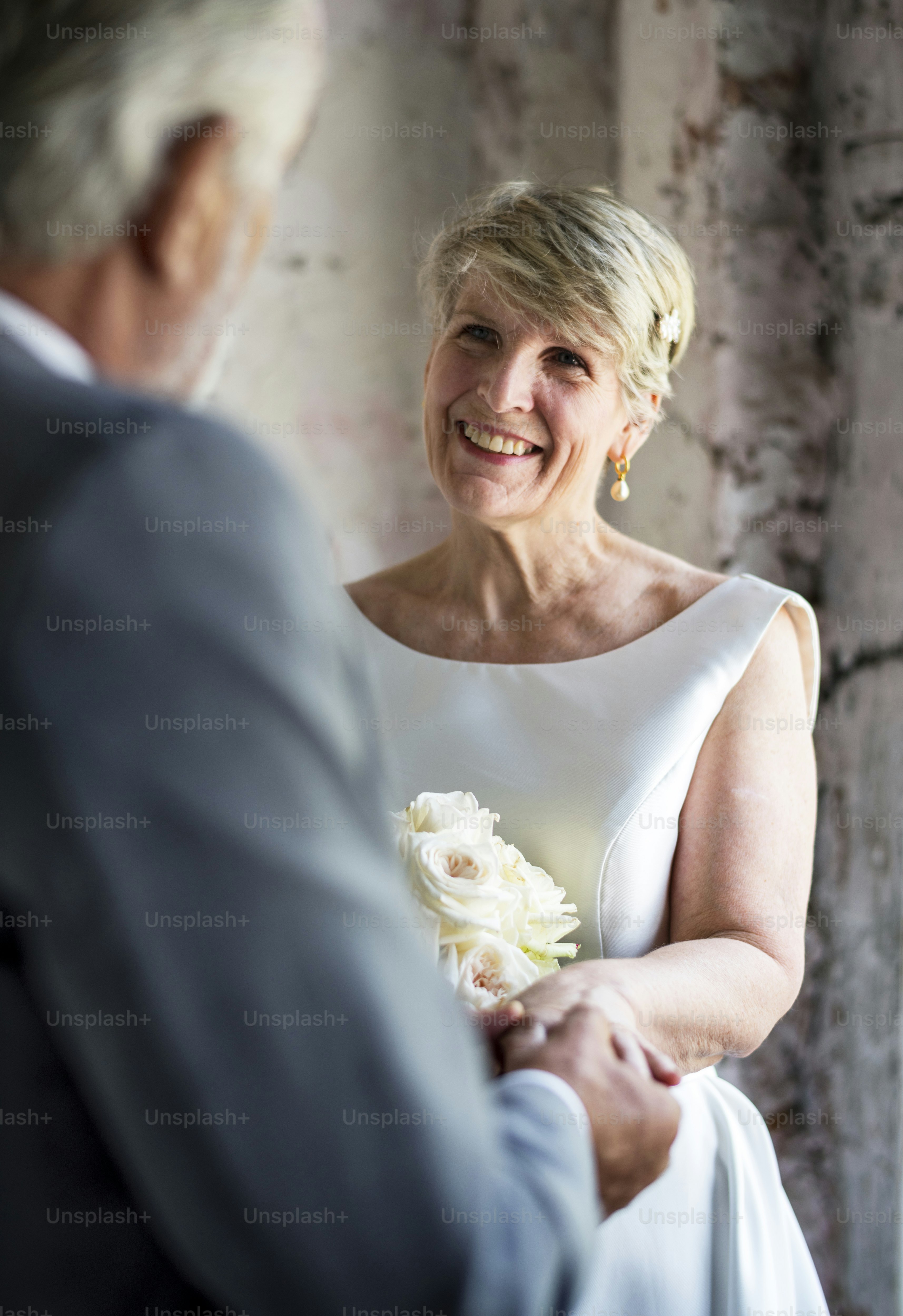 Senior couple with flower bouqet smiling