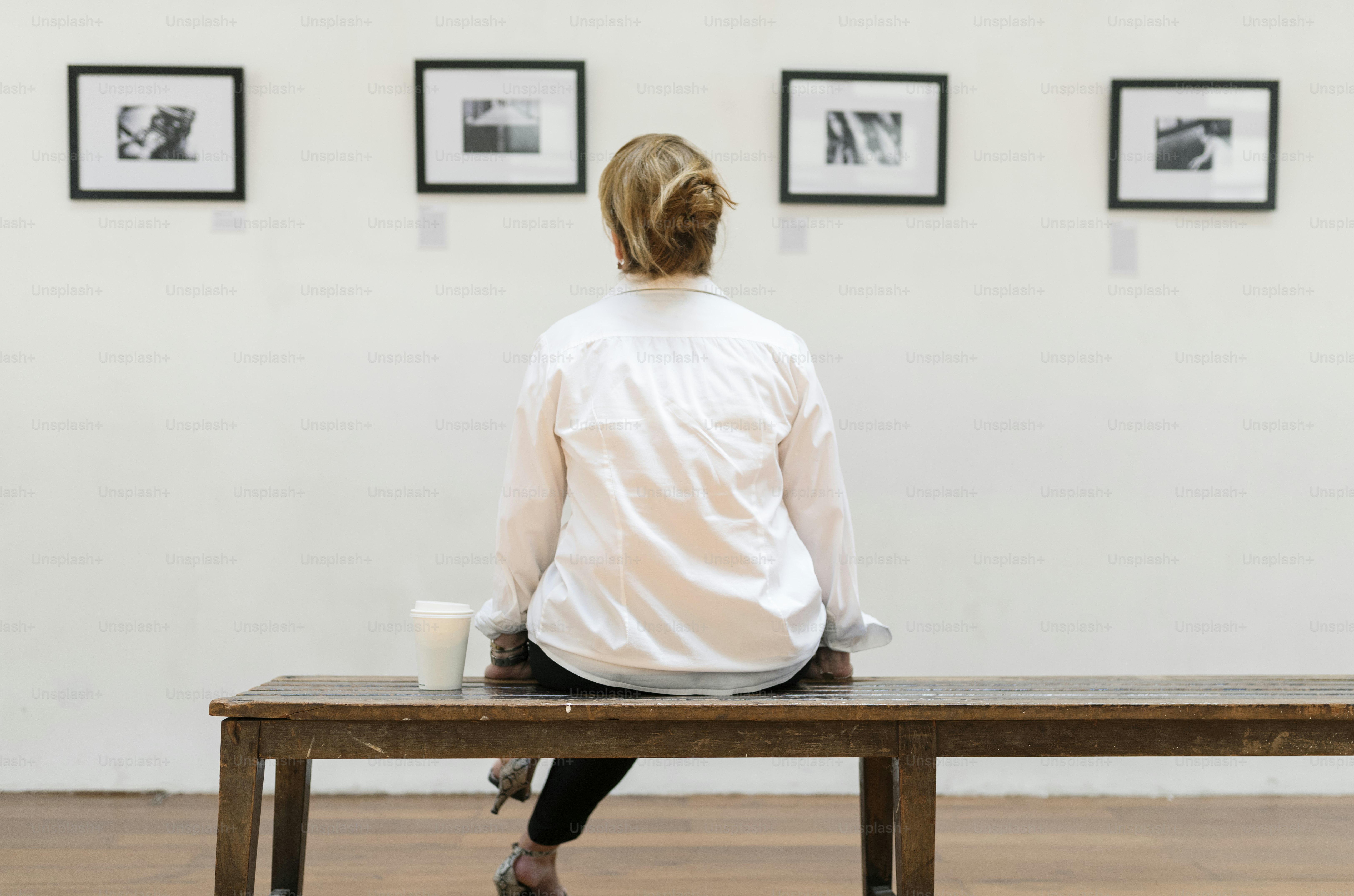 Woman looking at frames in an exhibition