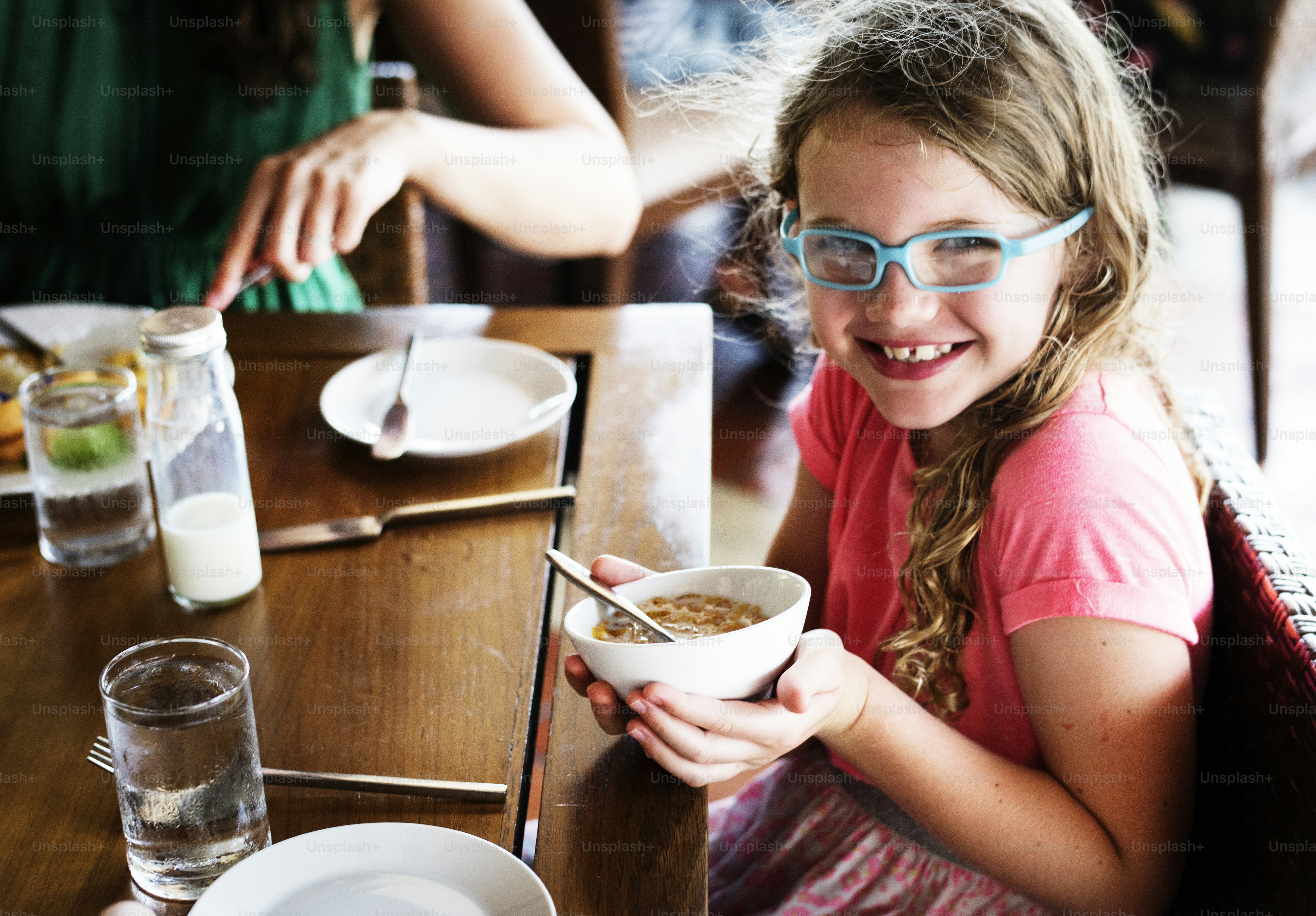 A girl holding her cereal bowl
