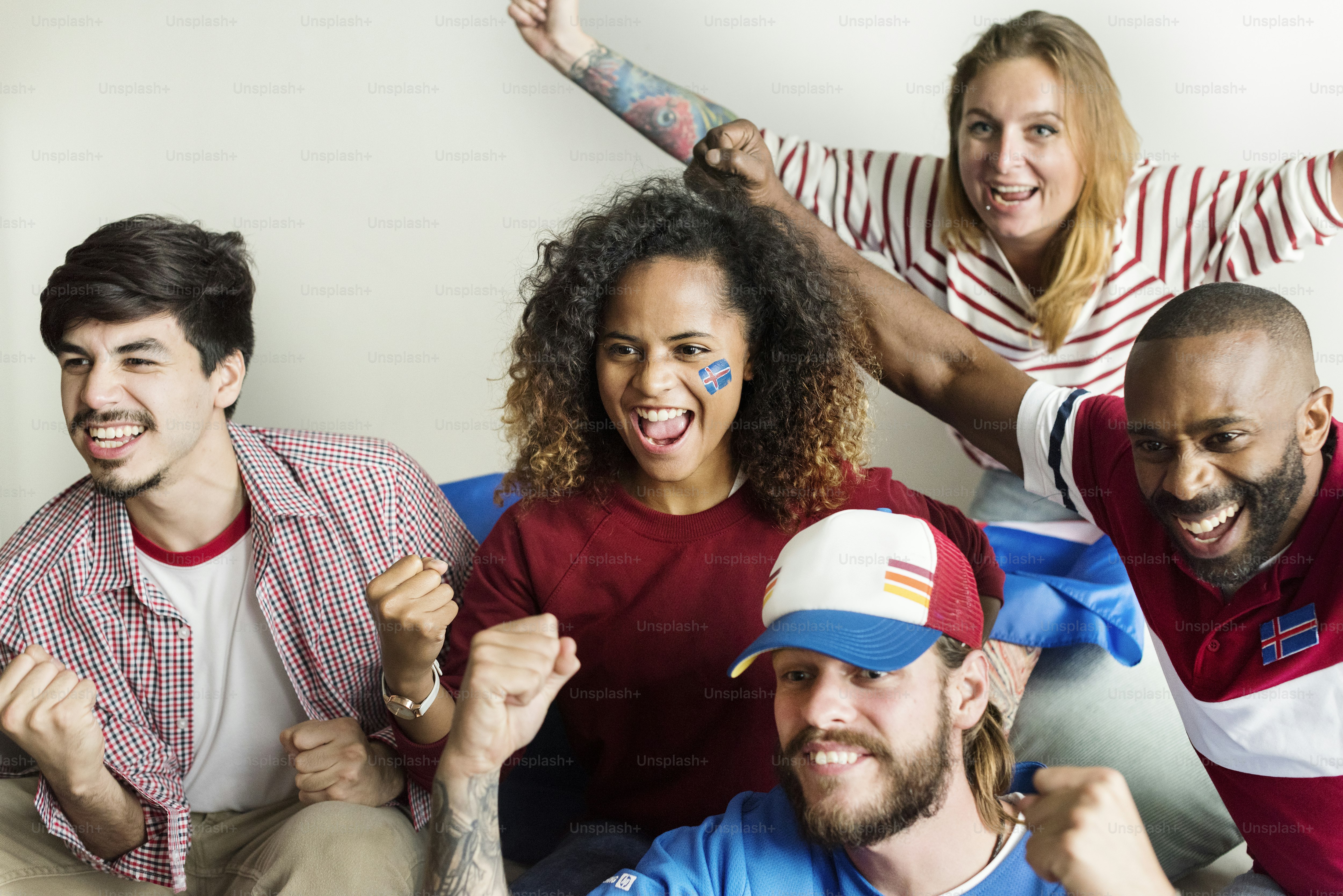 Friends cheering world cup with painted flag