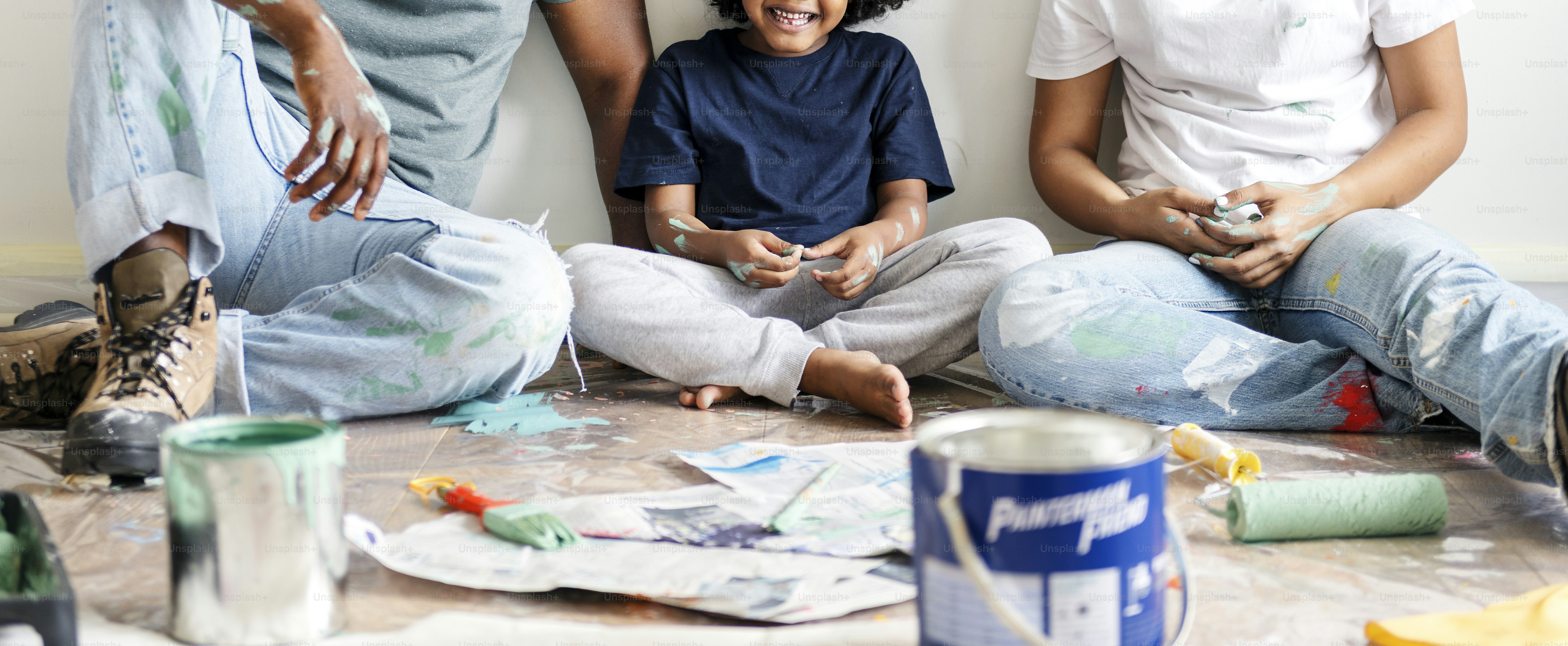 Black family painting house wall