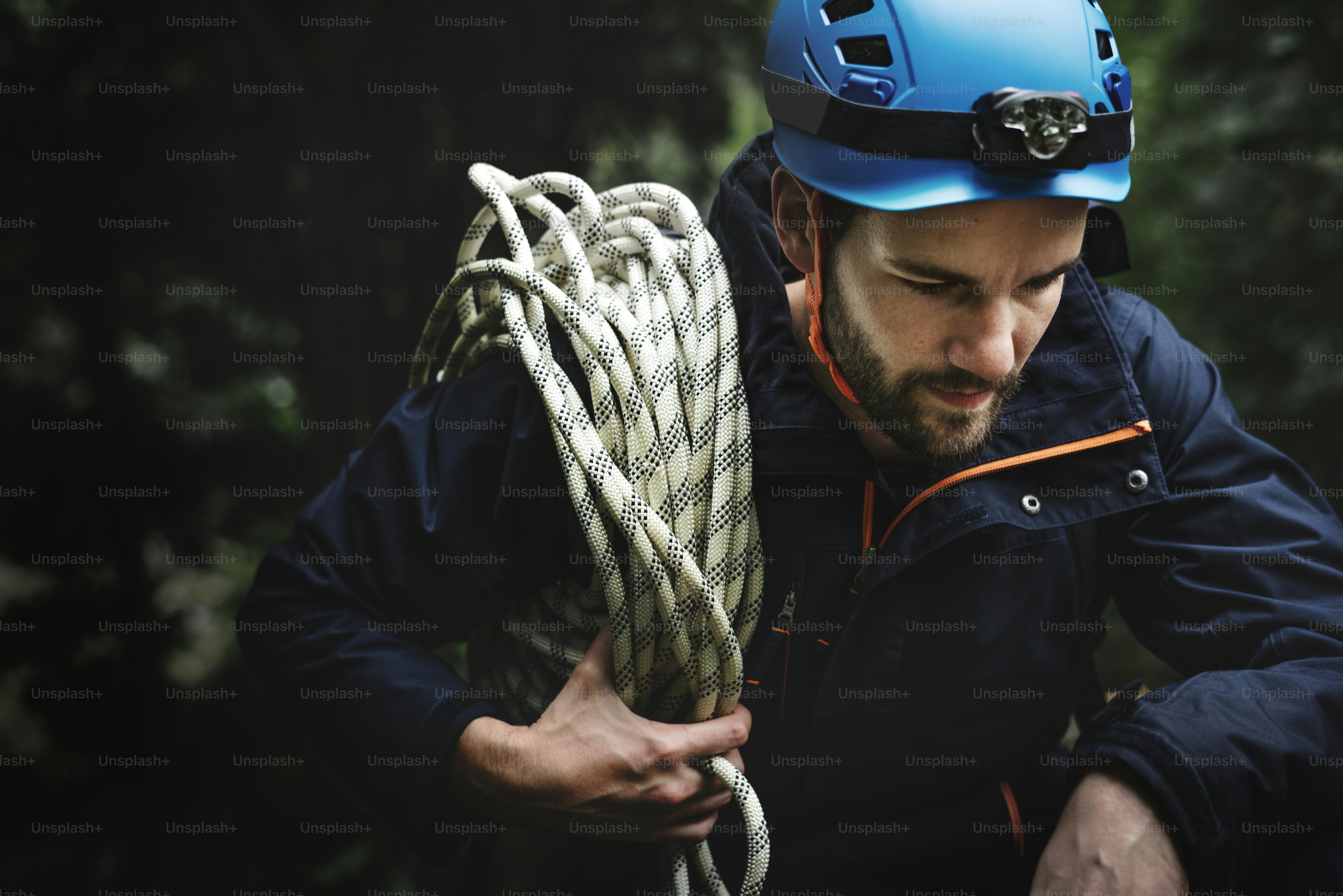 Man with climbing rope alone in the forest