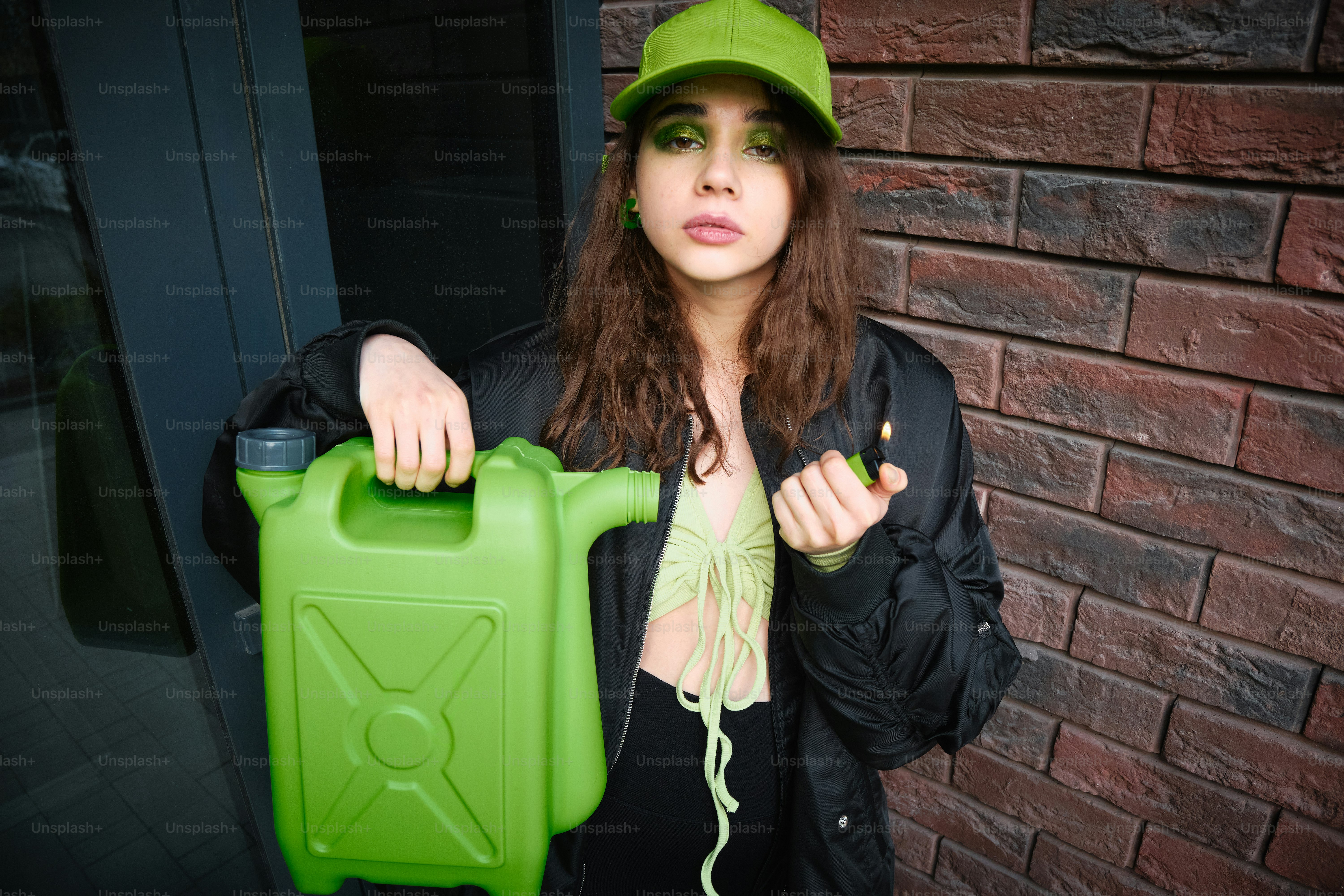 A woman in a green hat holding a green plastic container