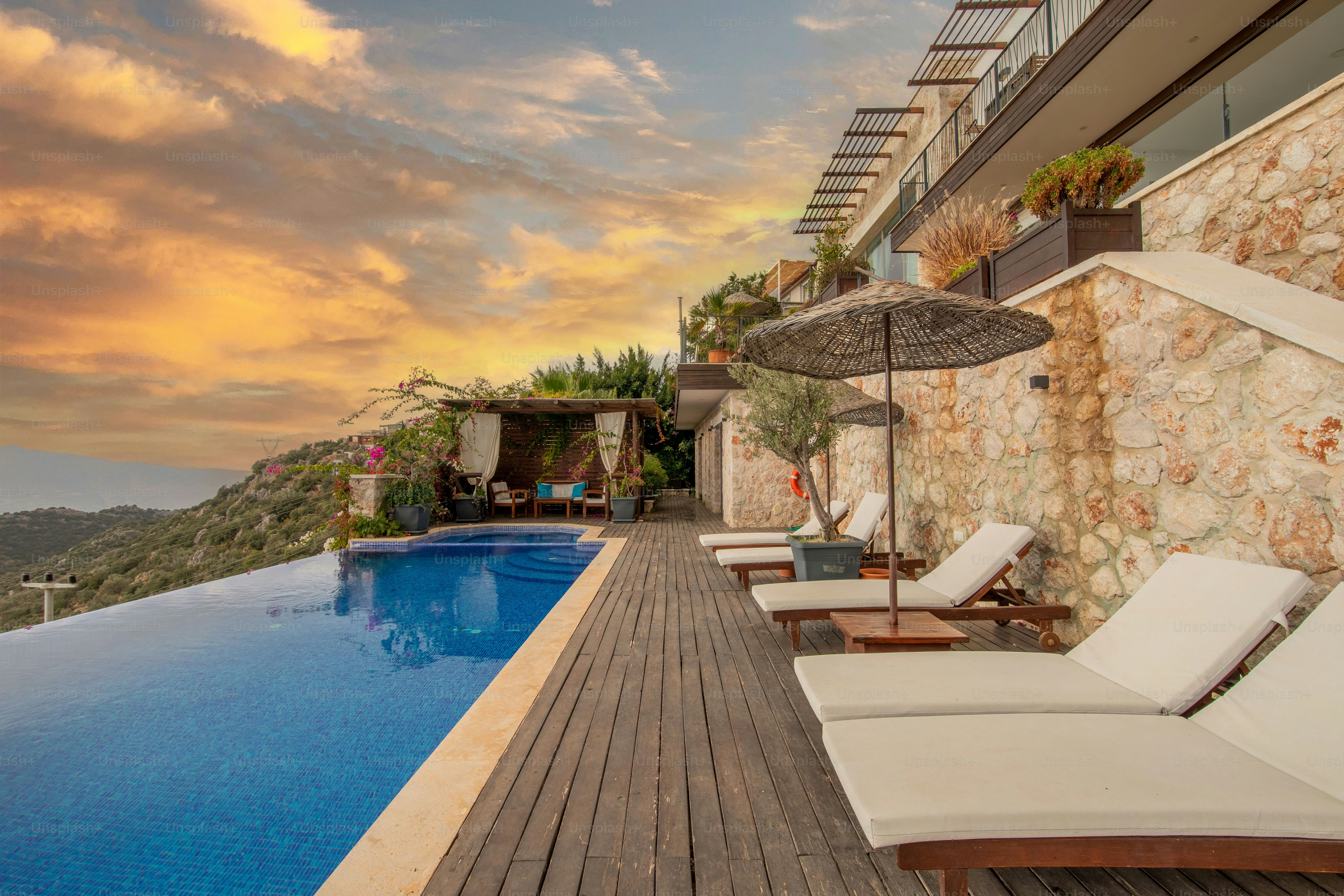 Private pool villas overlooking tropical scenery at sunset