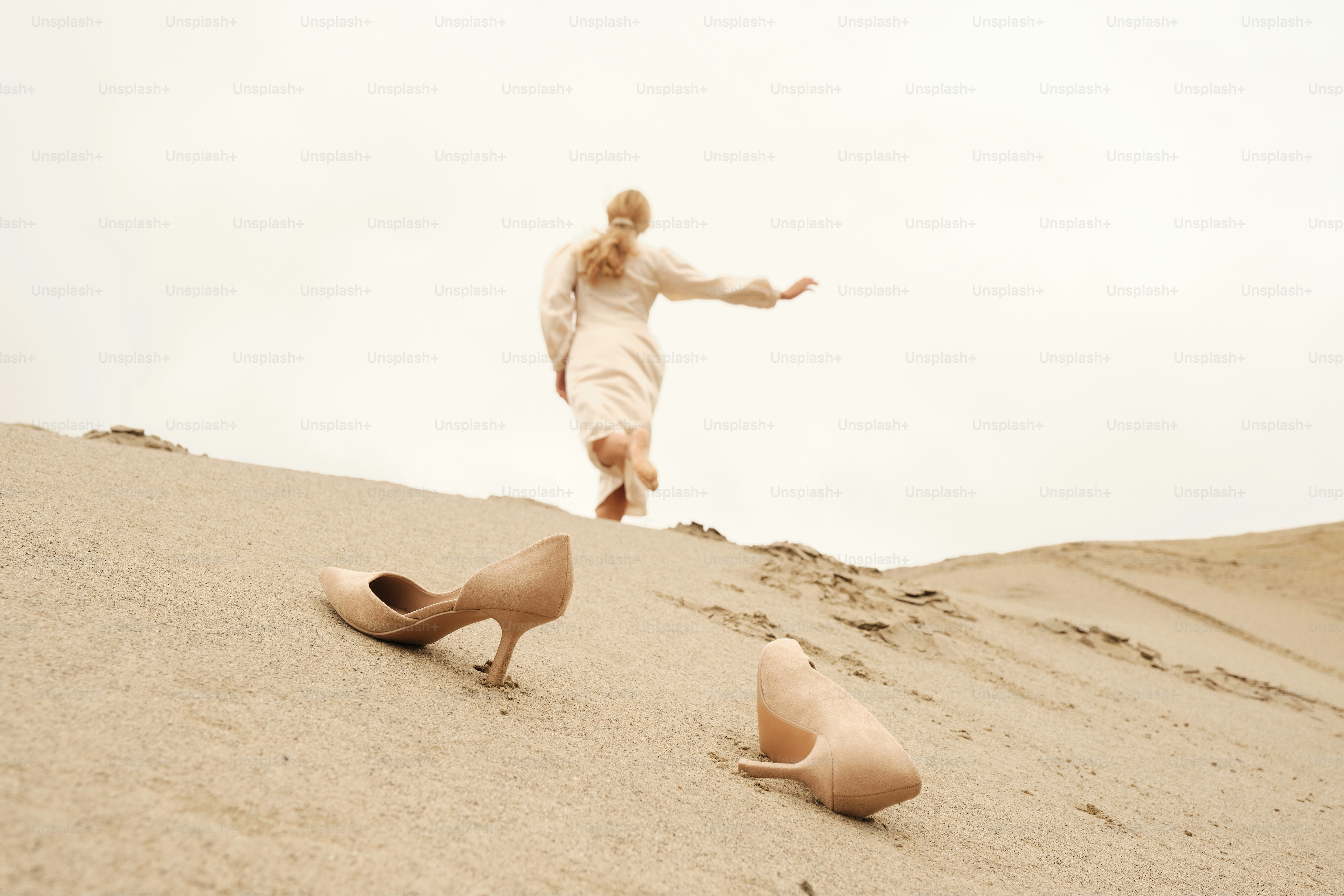 A man standing on top of a sandy hill