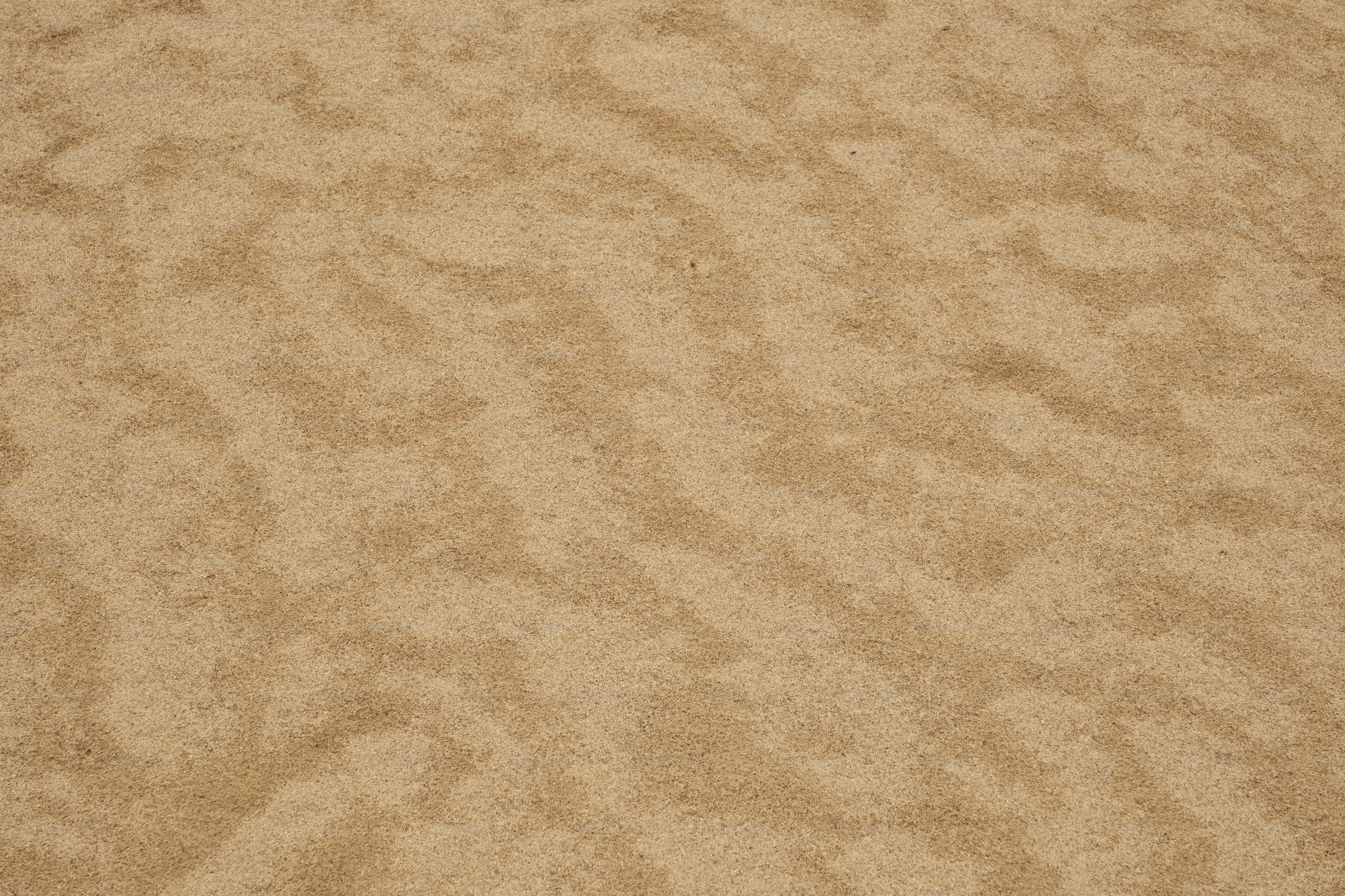 A close up of a tan carpet with a white background