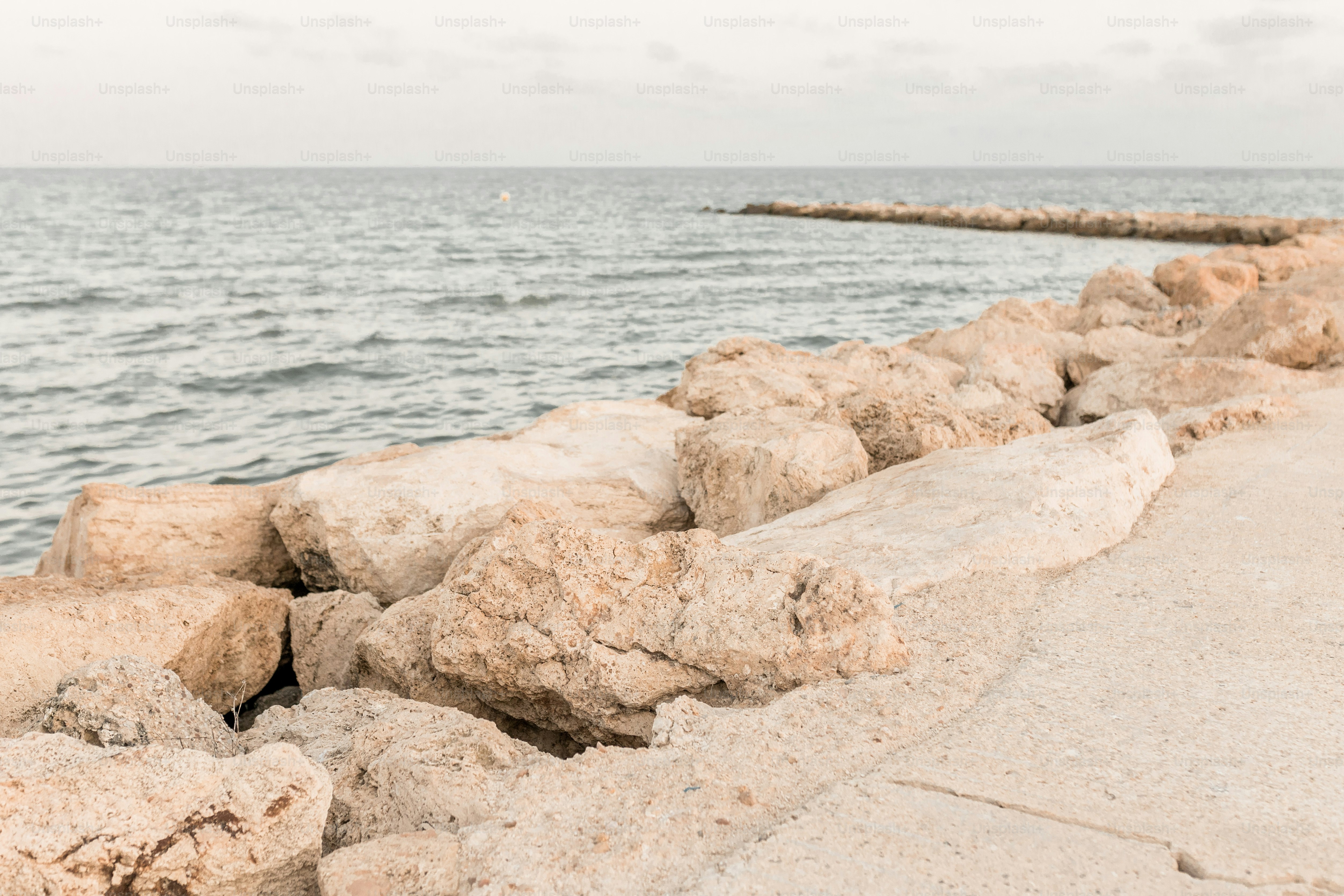 A person walking along a beach next to the ocean