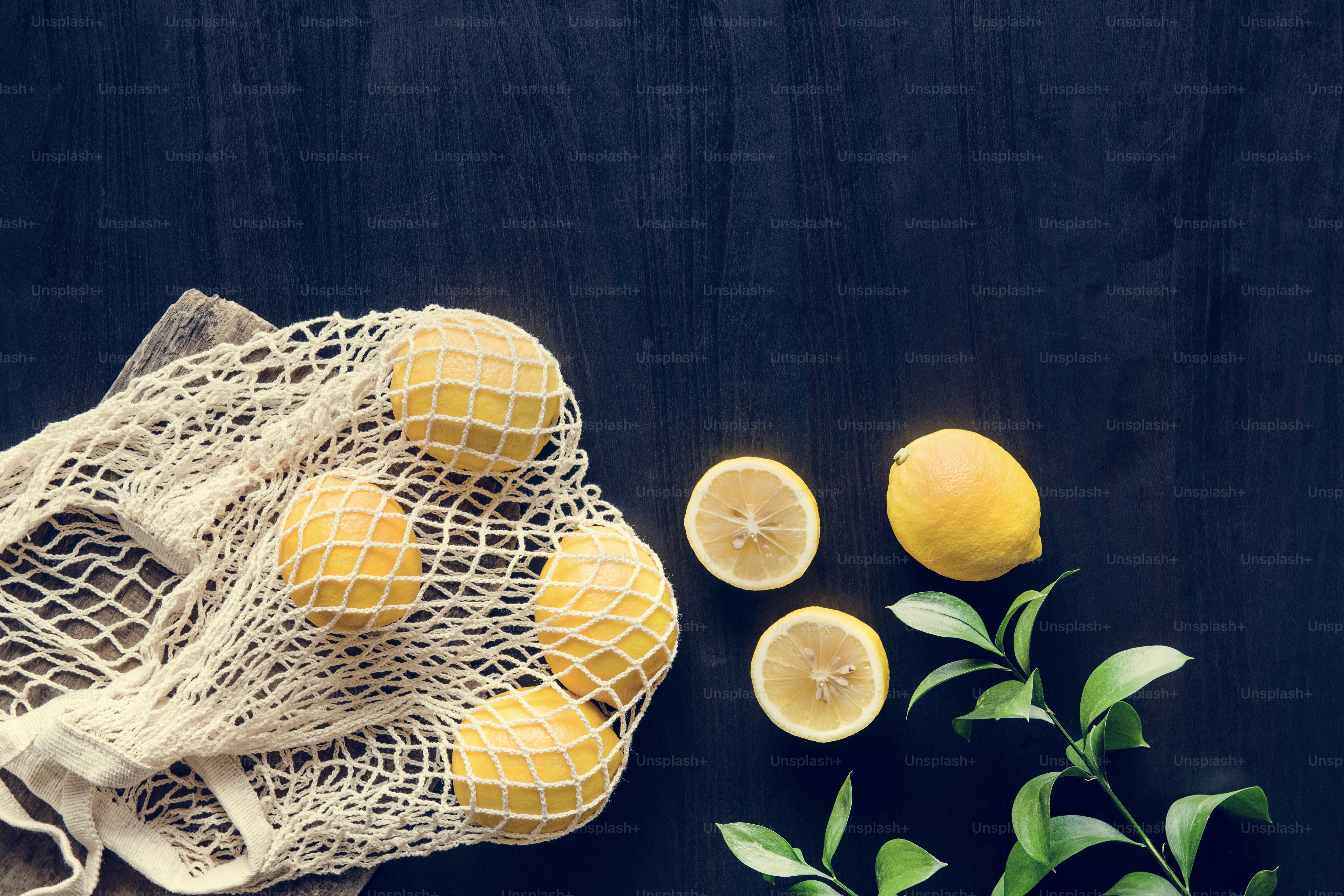 Fresh yellow lemons on black background