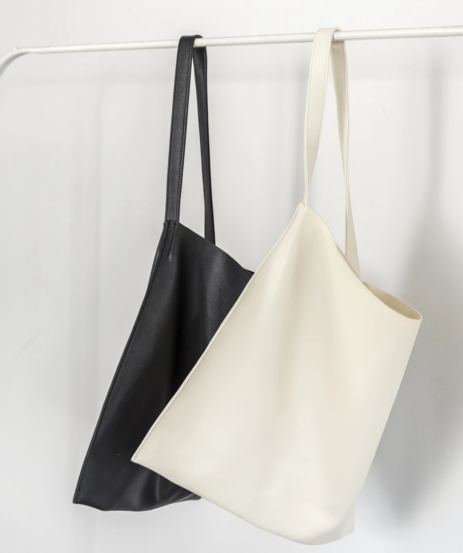 The Luminary Tote — a minimal structured leather bag on a soft cream background