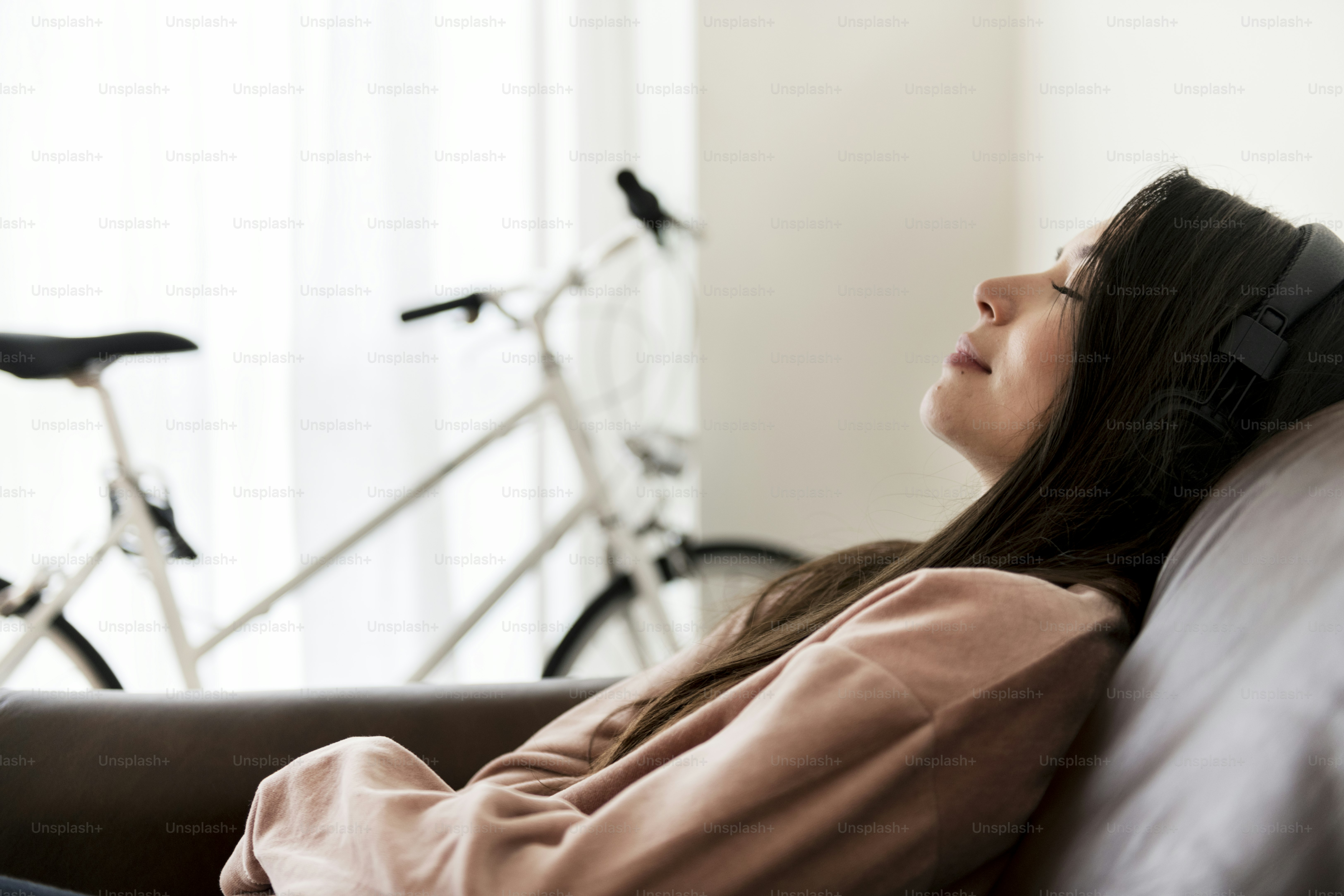 Girl listening to music at home on the sofa