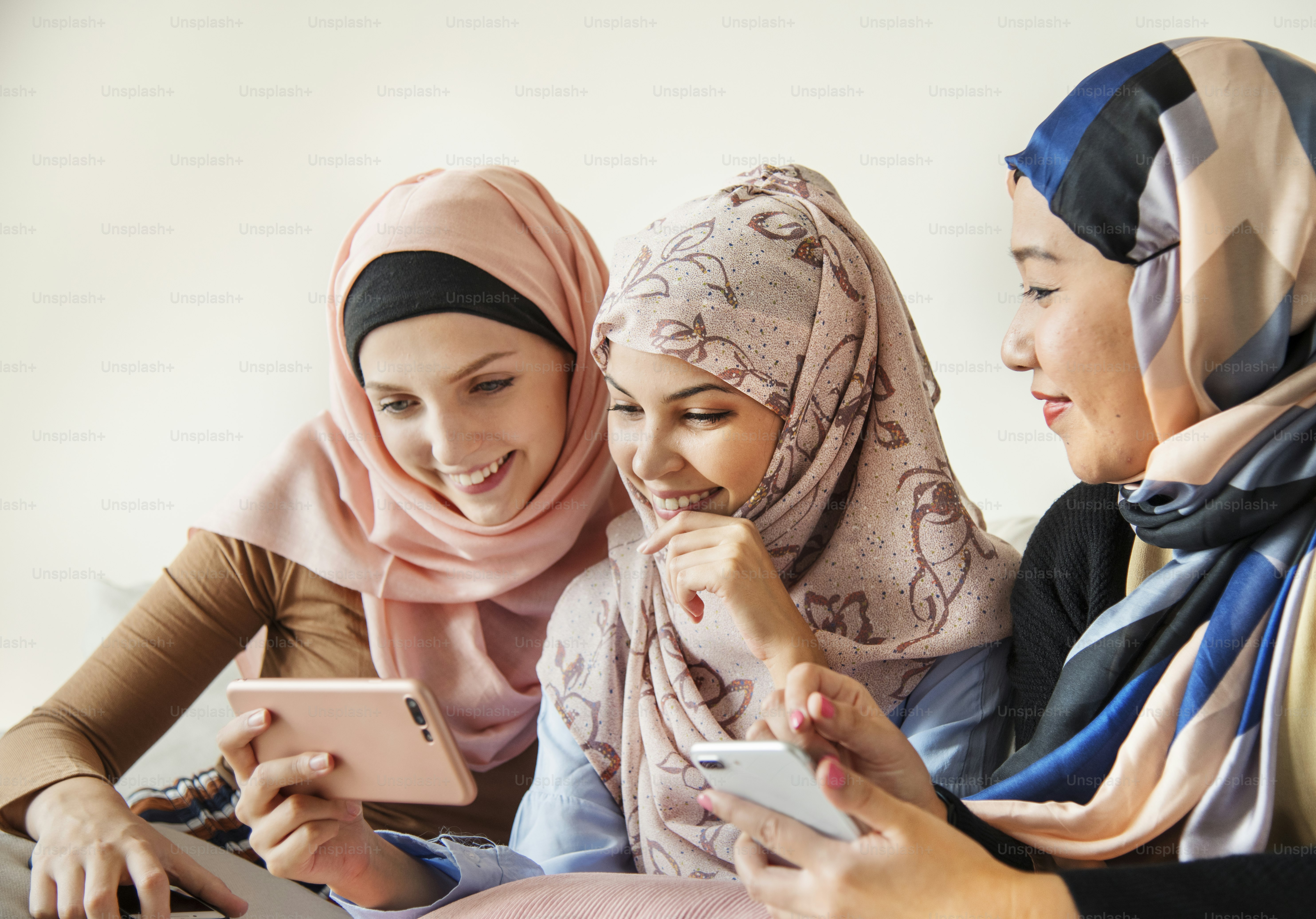 Group of islamic women talking and watching on the phone together photo ...