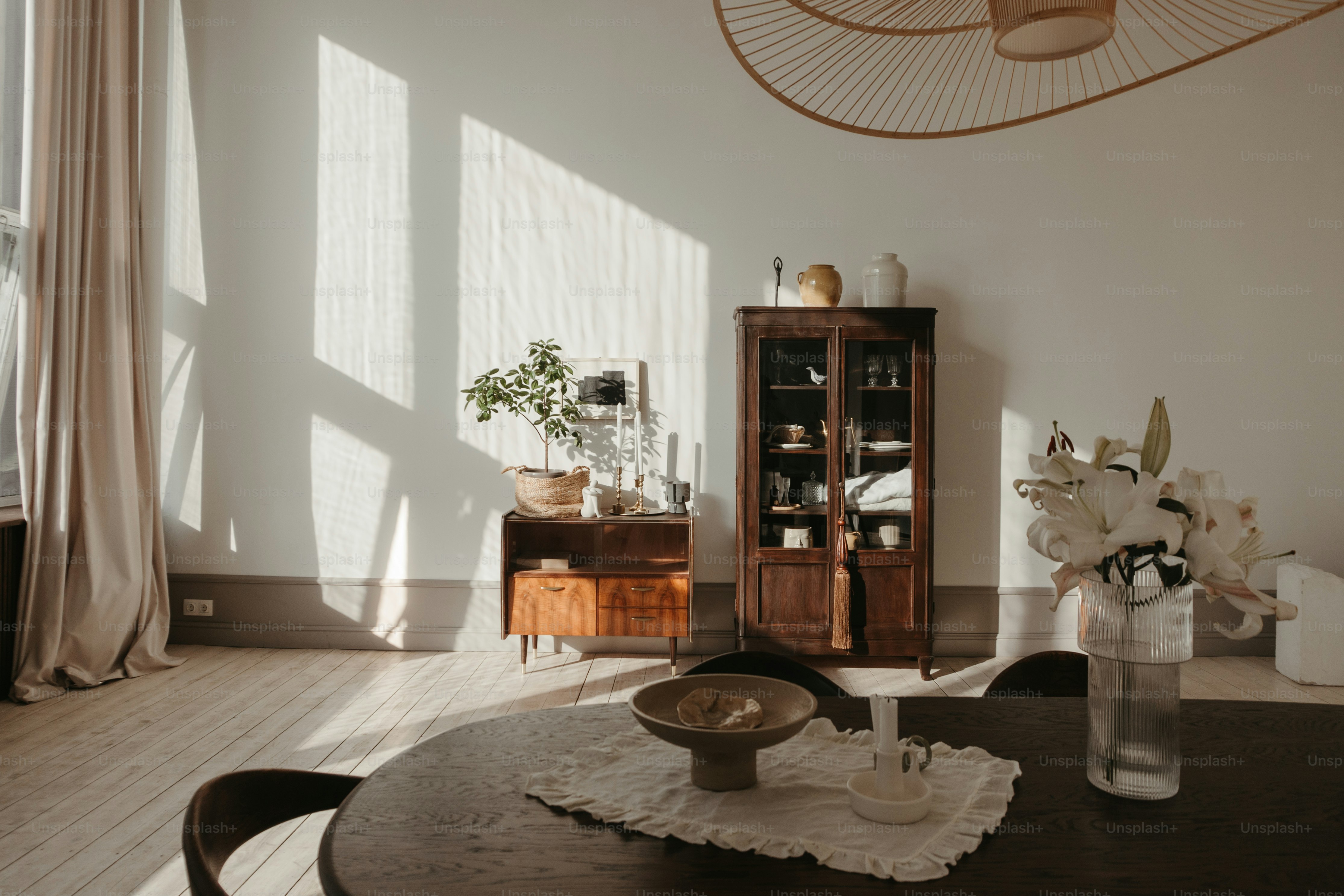 A dining room table with a vase of flowers on it