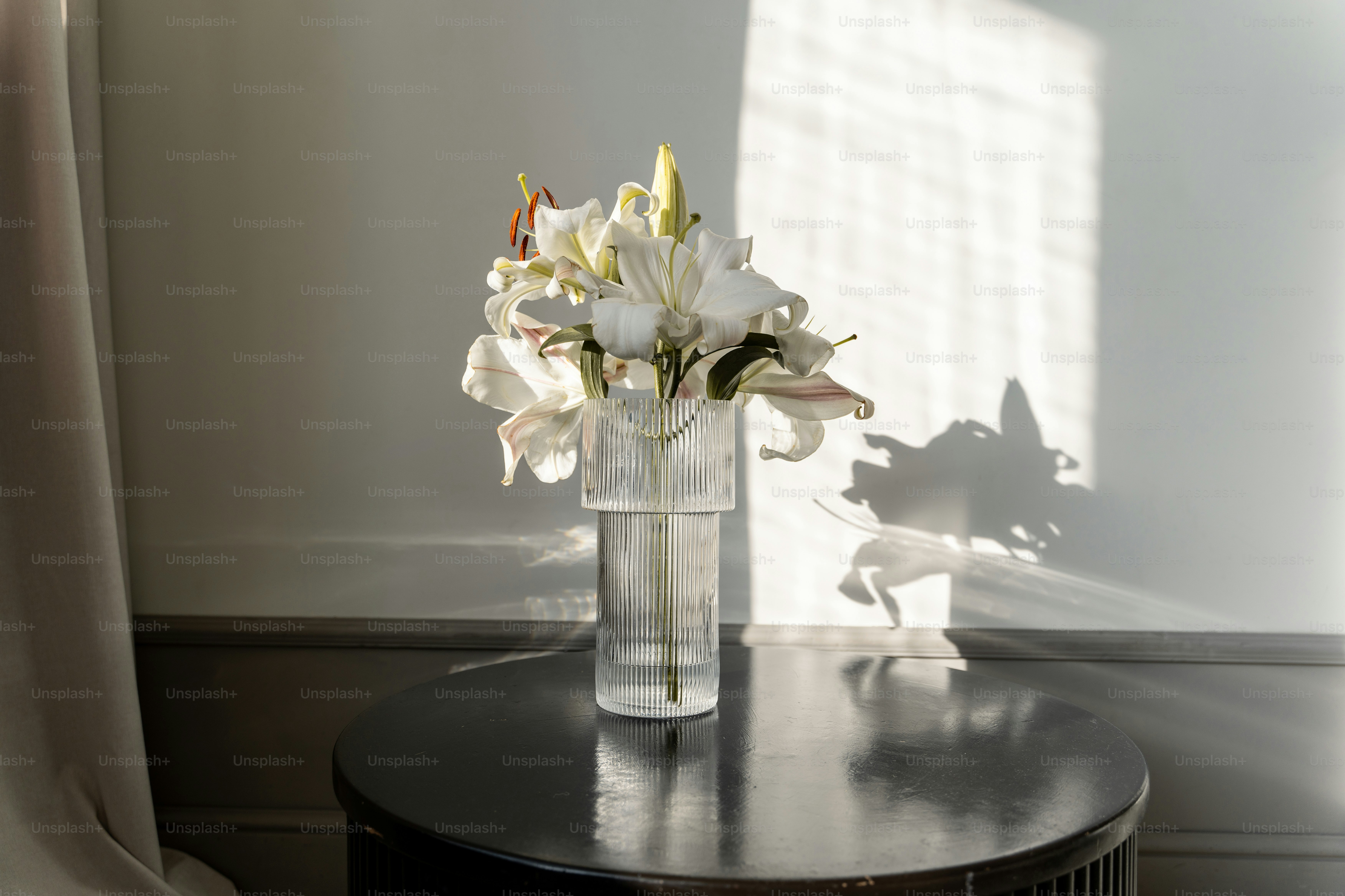 Elegant white funeral flower colors in a memorial arrangement featuring lilies and roses