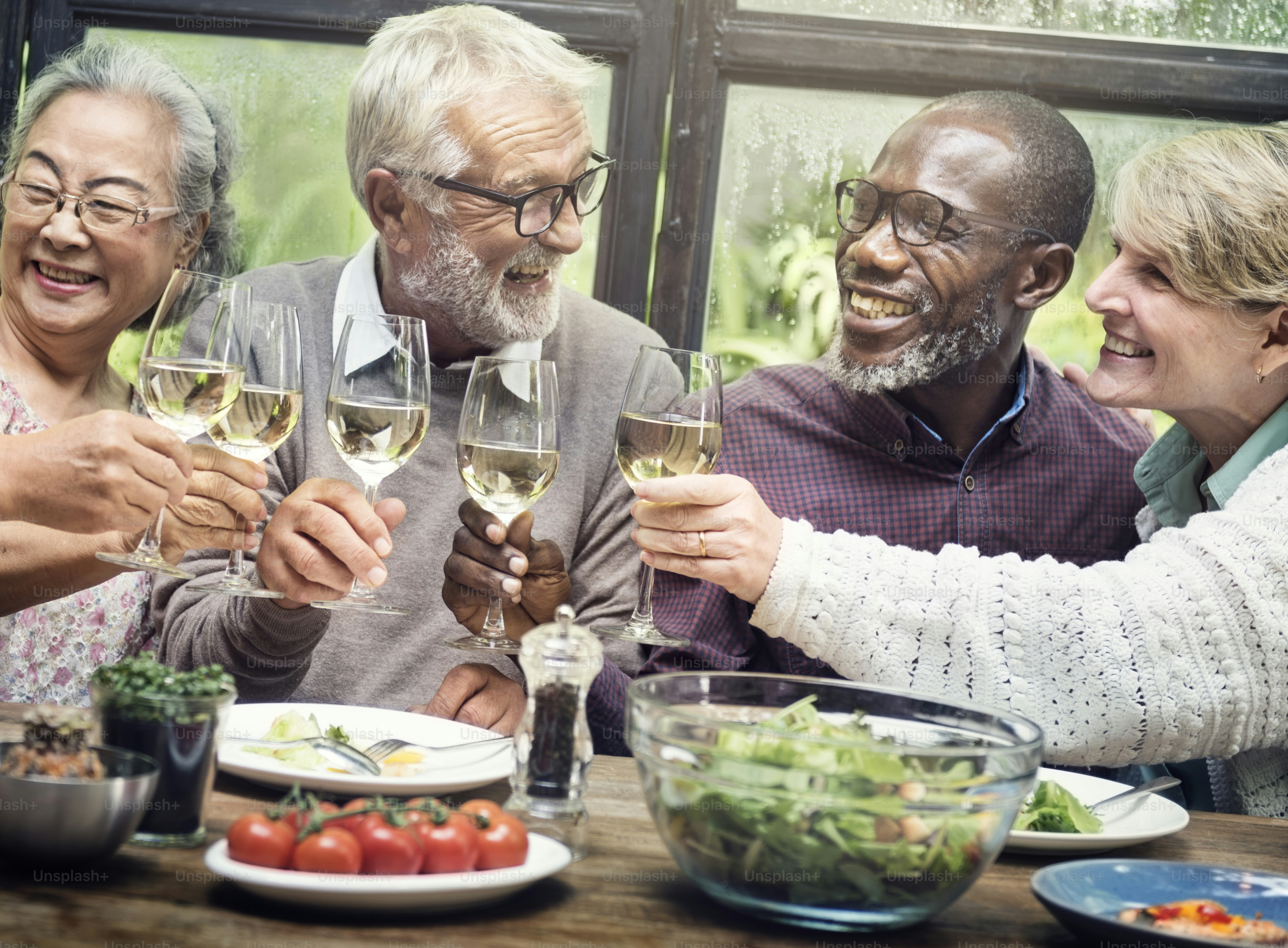 Group of friends enjoying wine together at a retirement gathering