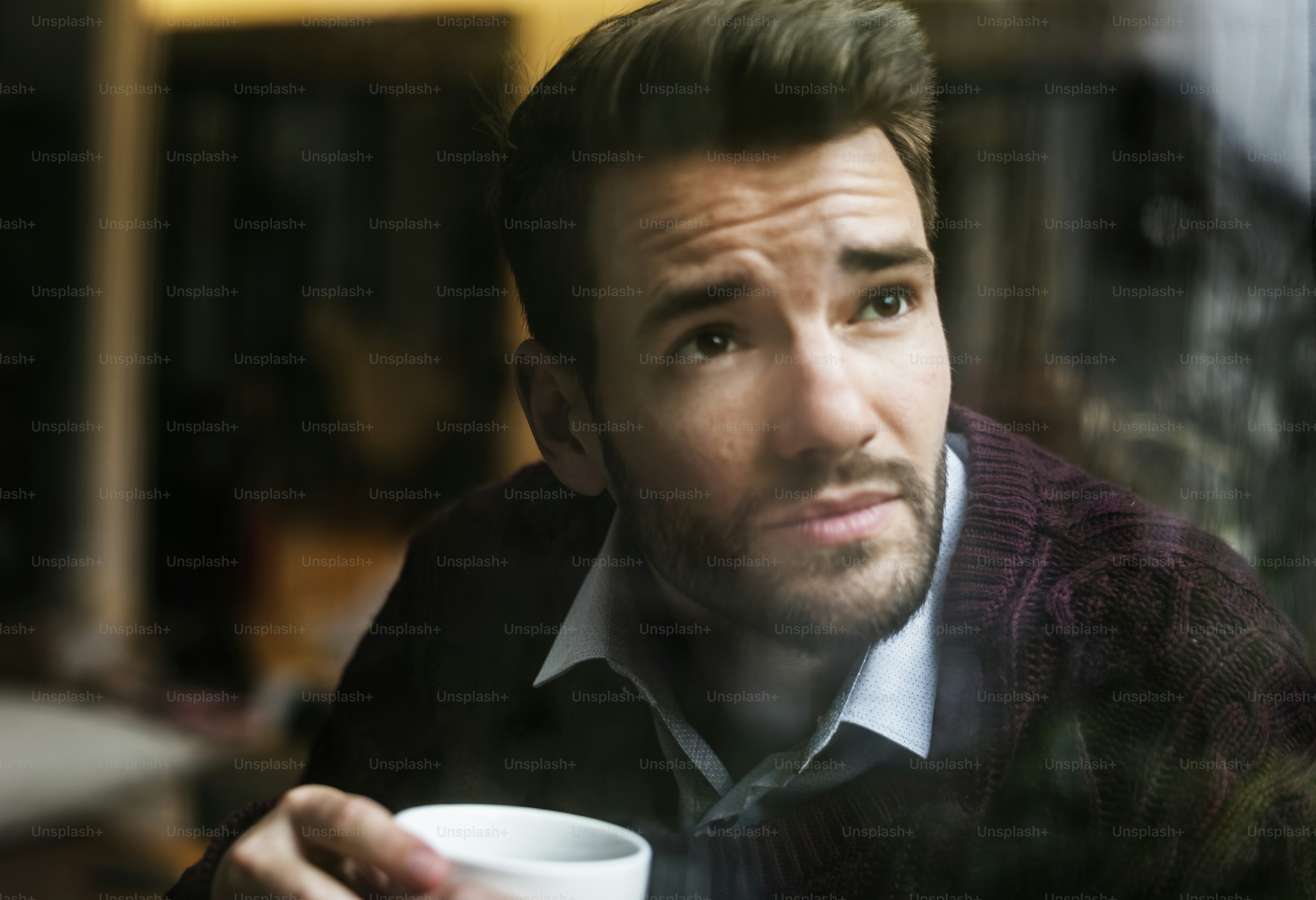 Contemplating man looking out the window