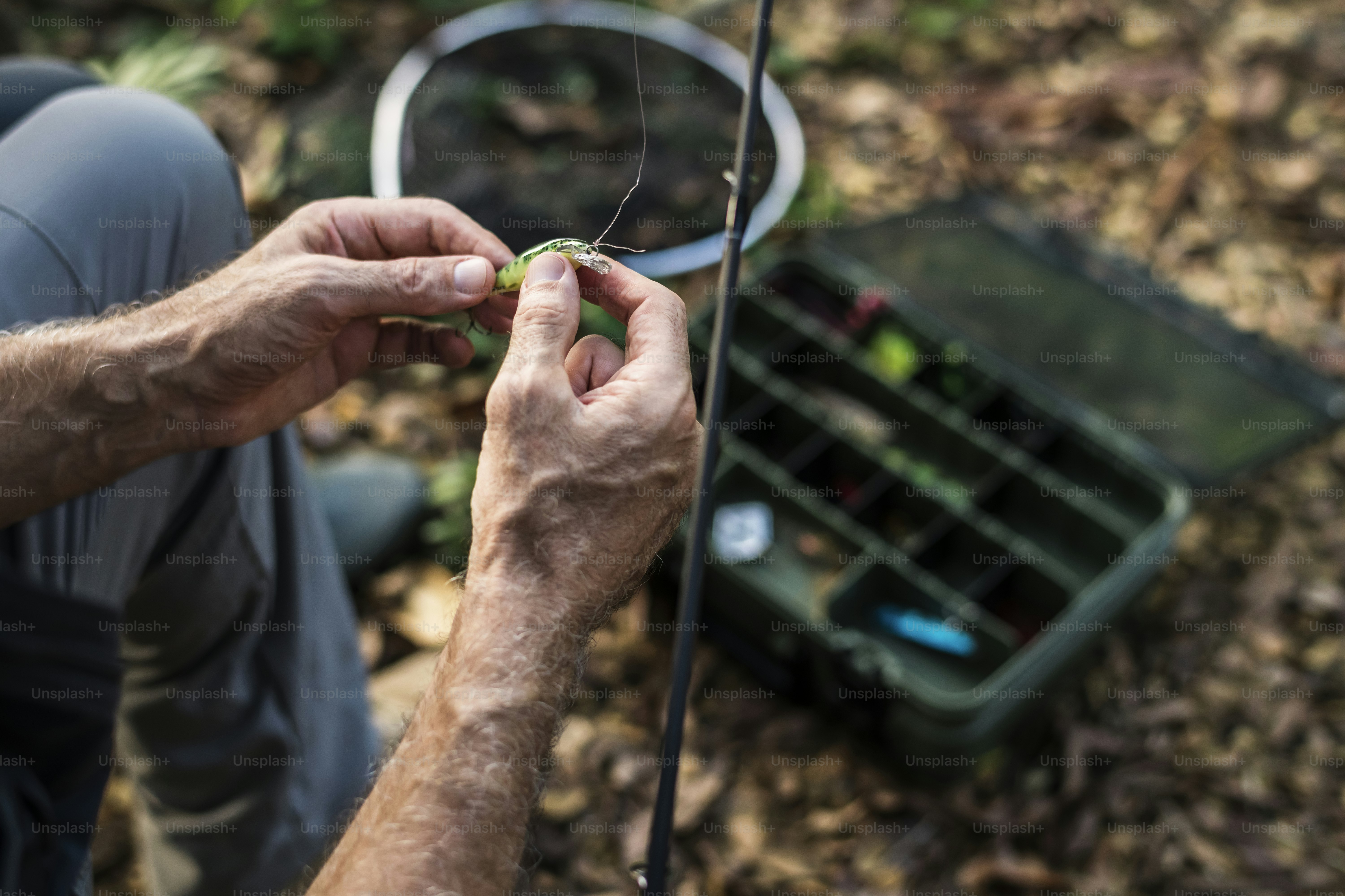 Closeup of a fisherman putting on bait