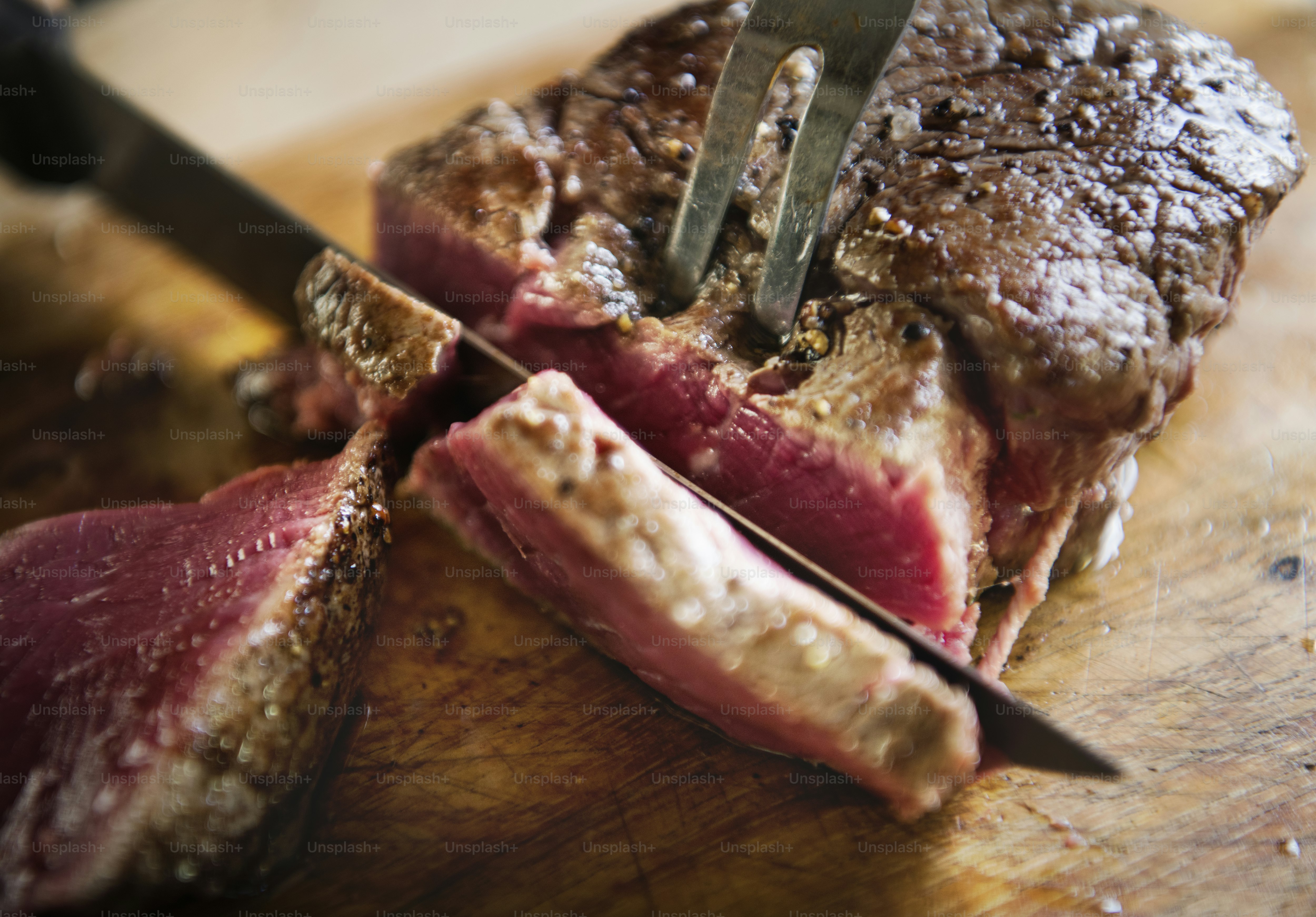 Cutting a cooked fillet steak food photography recipe ide