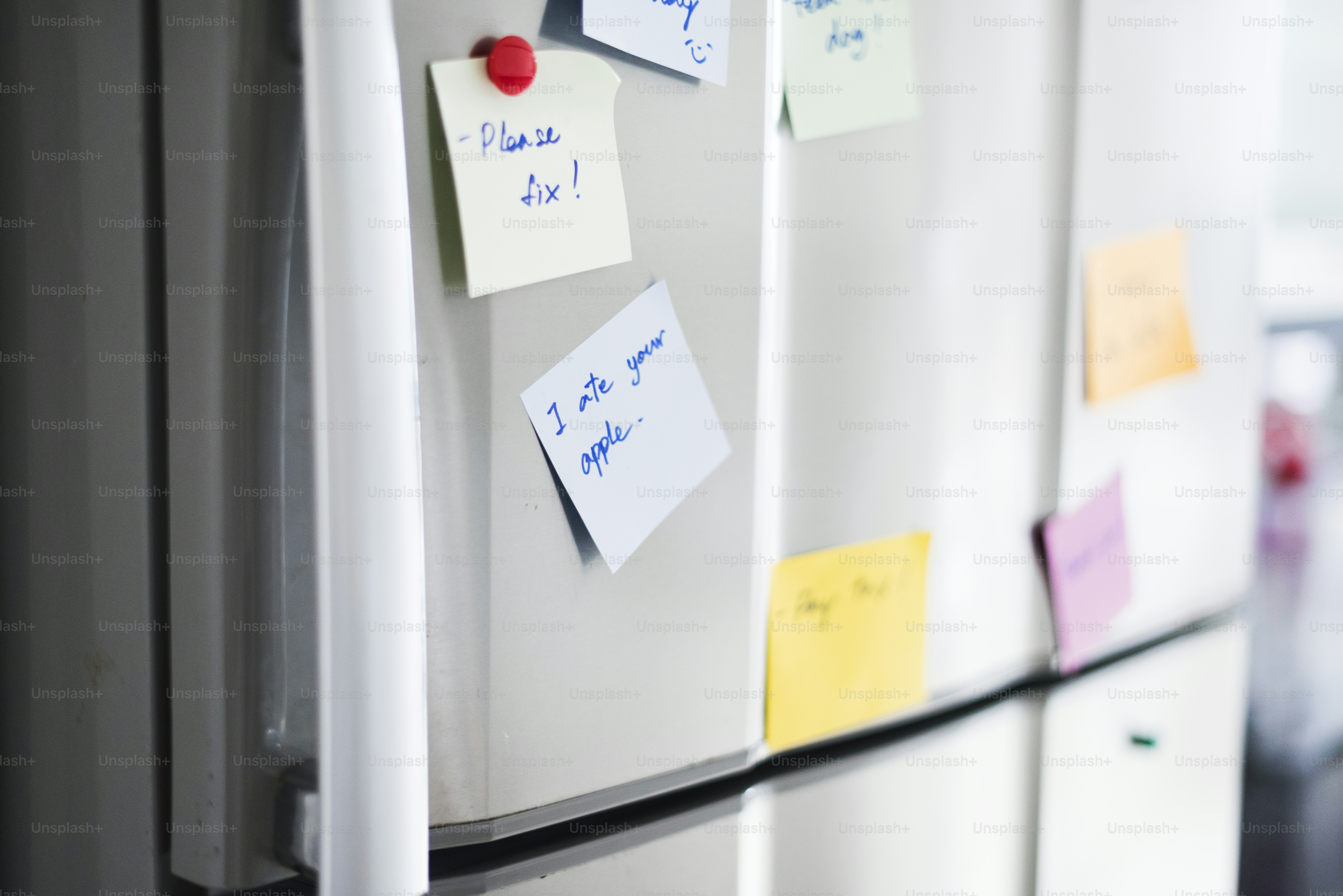Closeup of reminder paper note on fridge door