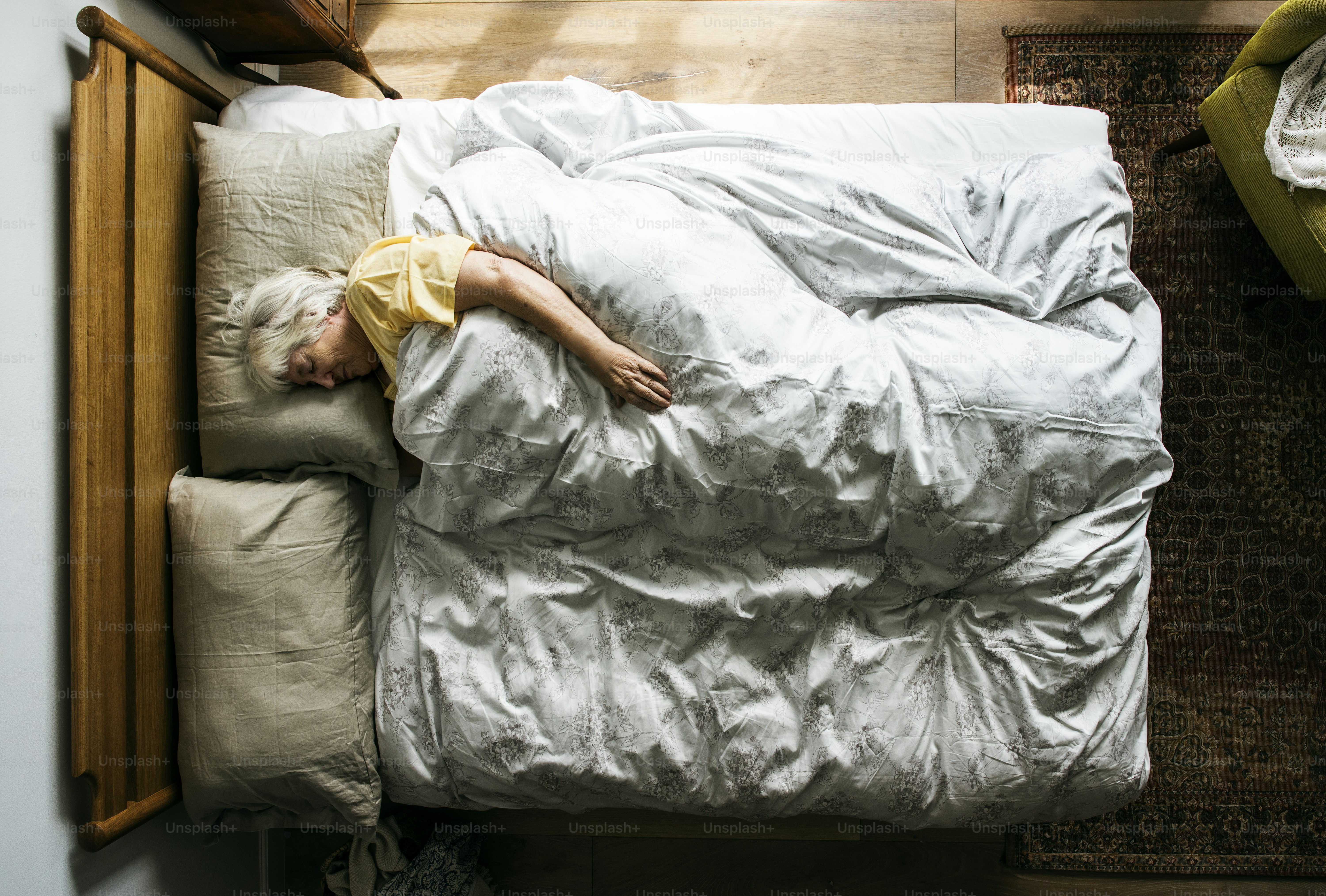 Elderly Caucasian woman sleeping on the bed