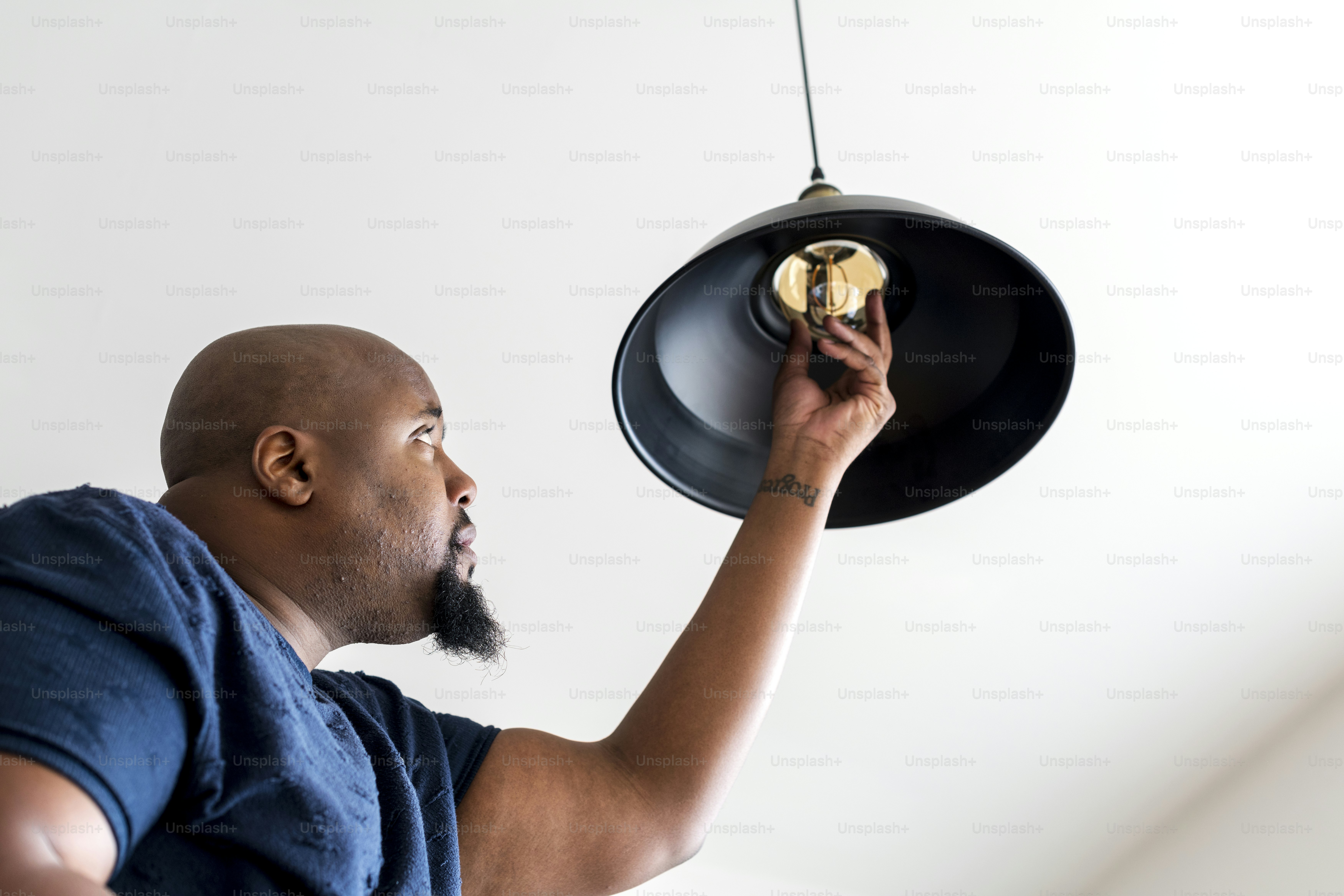 African descent guy changing a light bulb