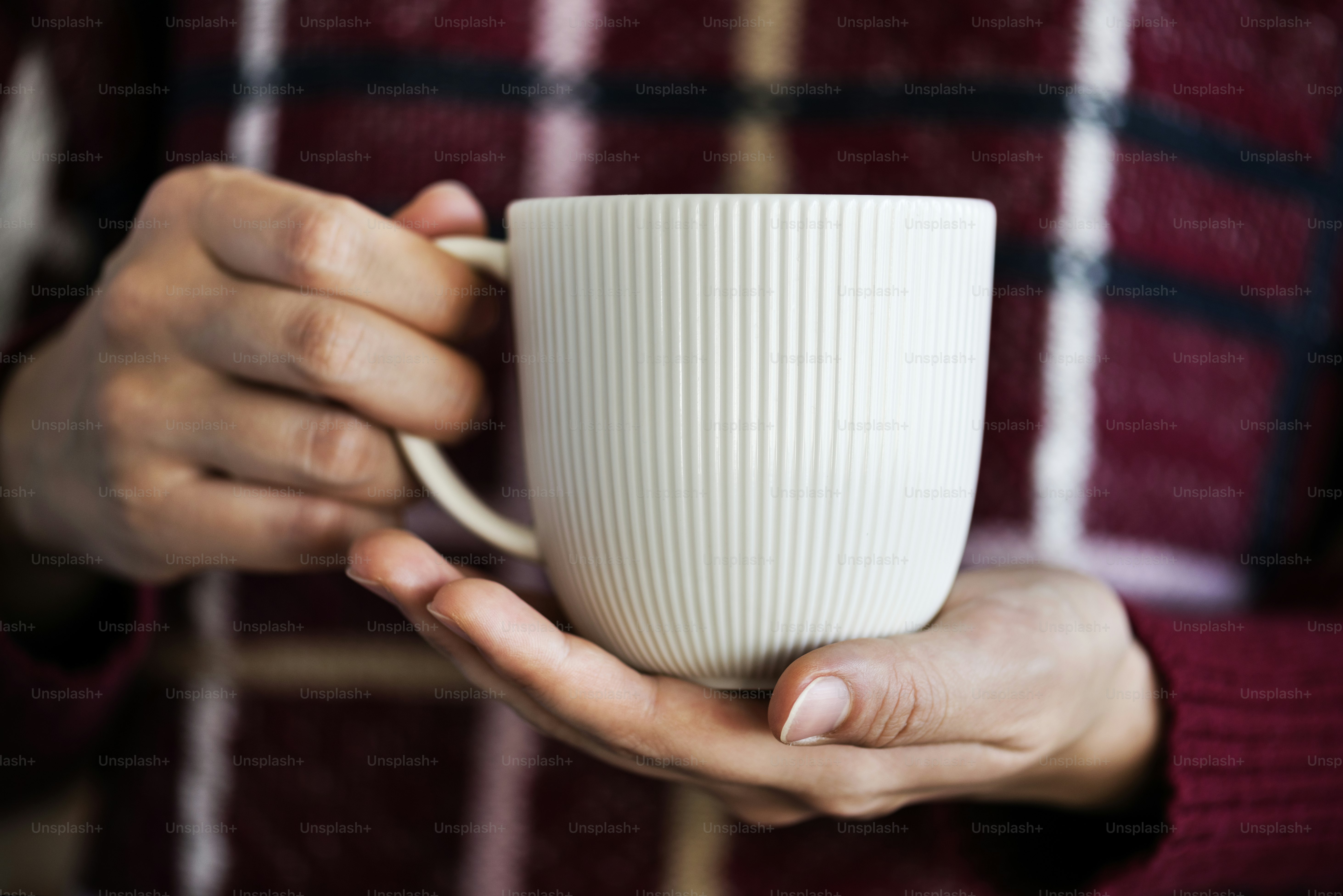 Closeup of woman holding hot drink cup