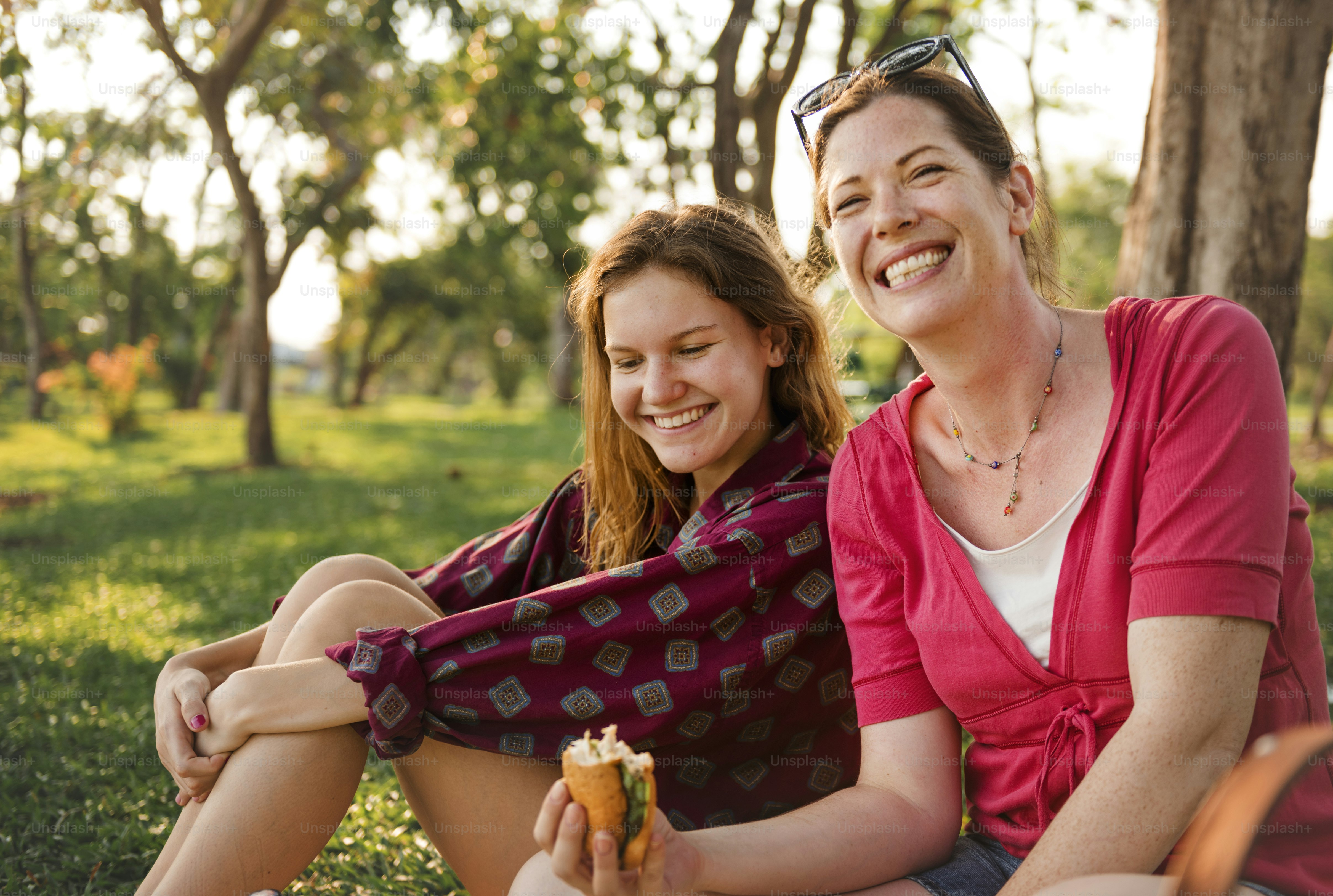 Mother and daughter having a picnic in the park