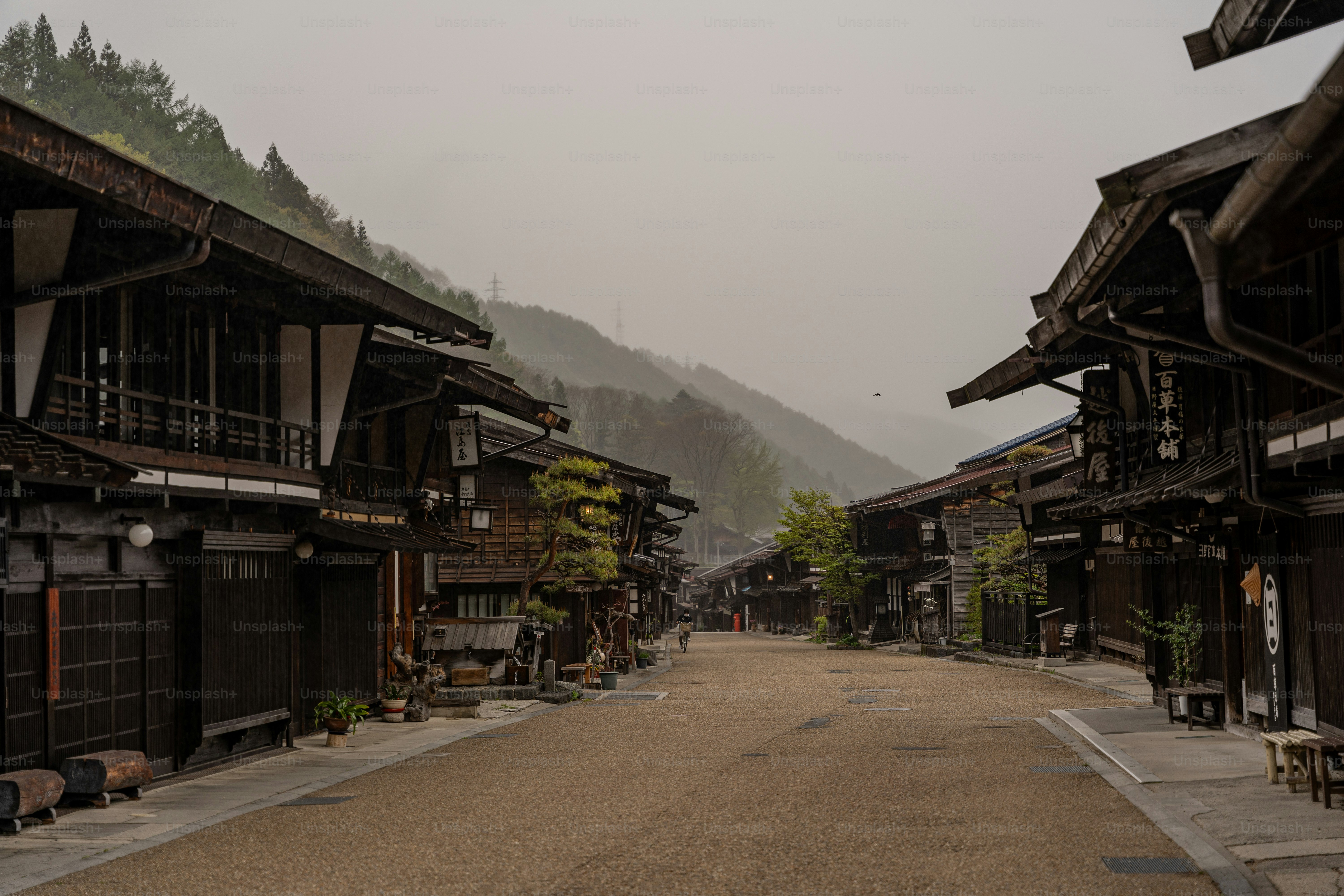 A street lined with wooden buildings on a foggy day