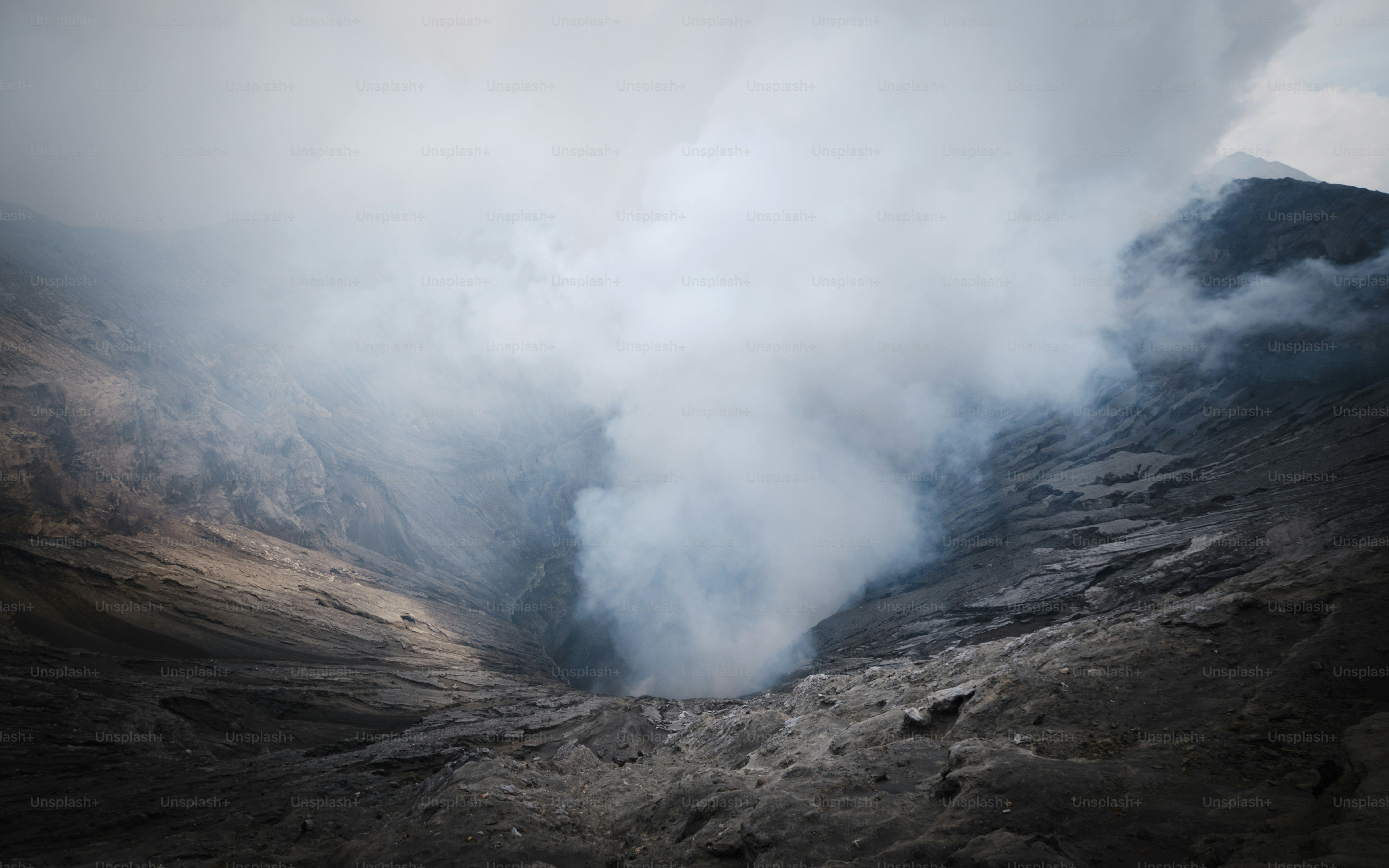 A large plume of smoke coming out of a mountain