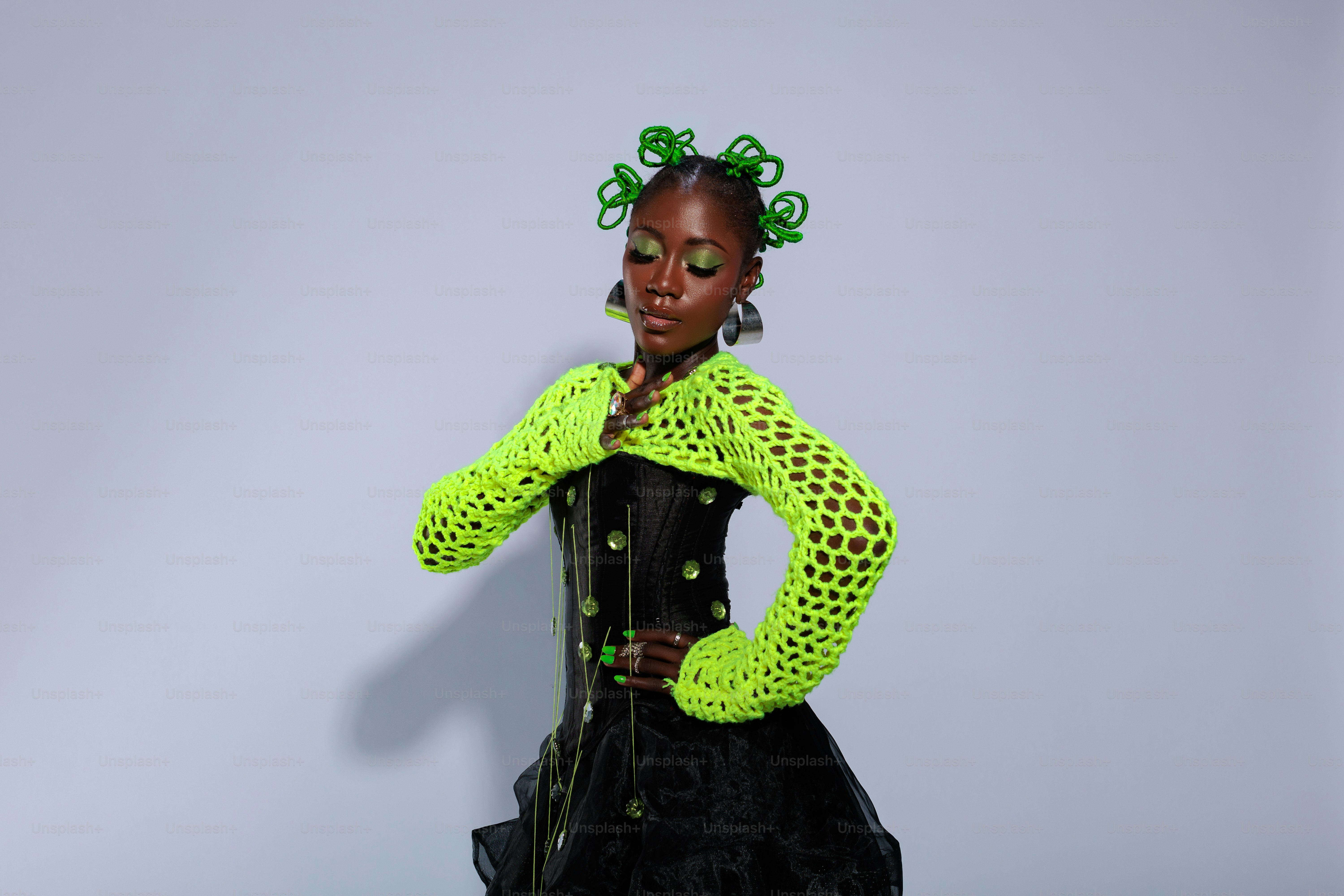 A woman in a green jacket and black dress