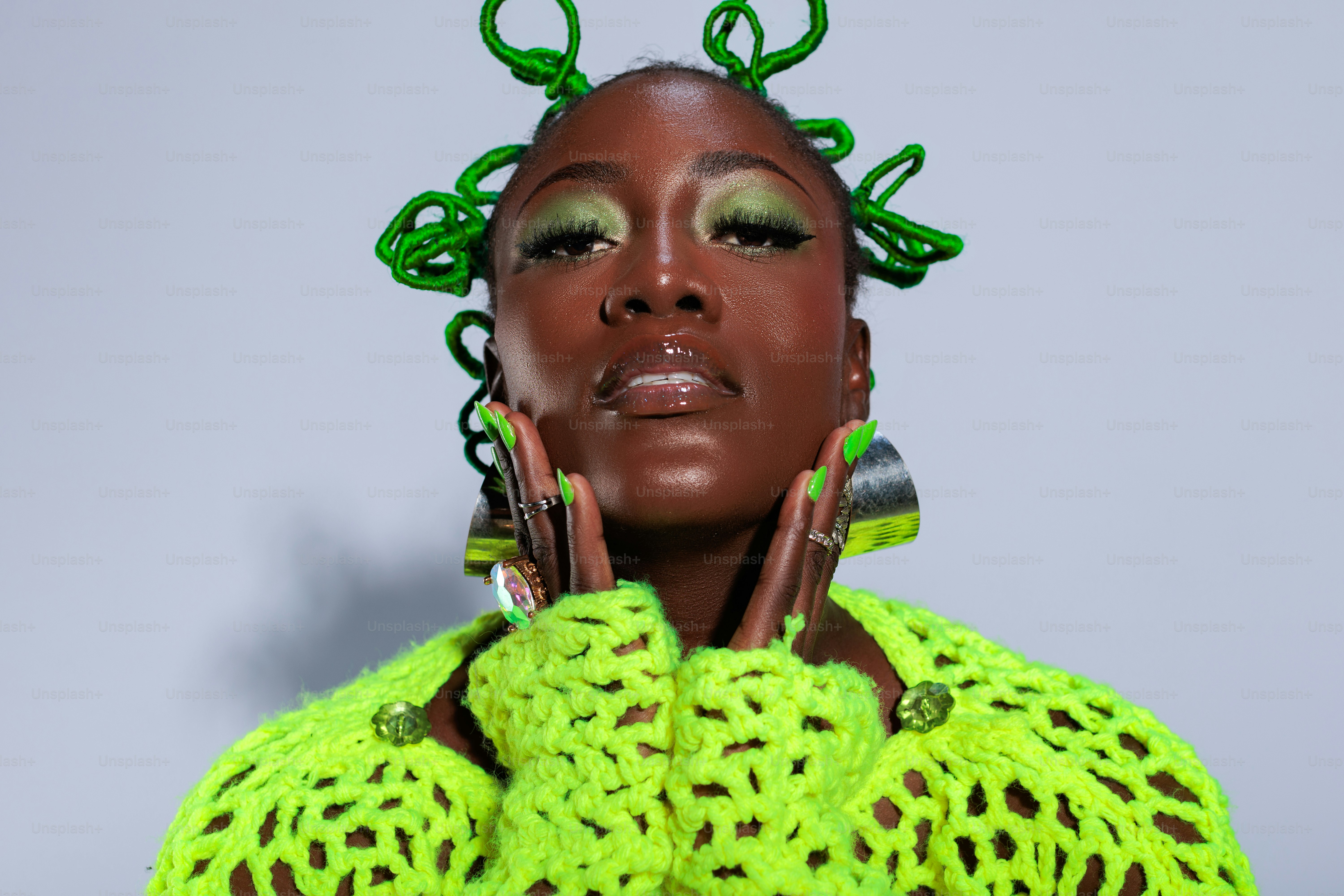 A woman with green hair and a green sweater